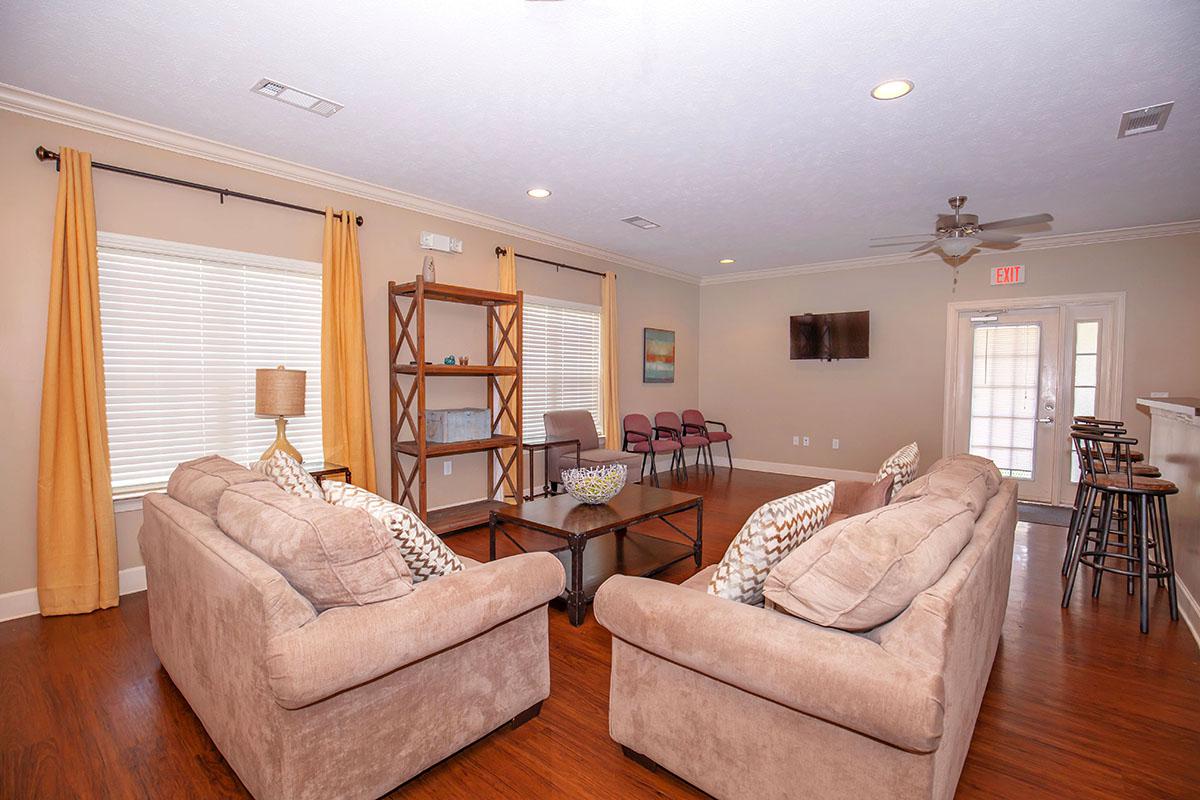 a living room filled with furniture and a flat screen tv