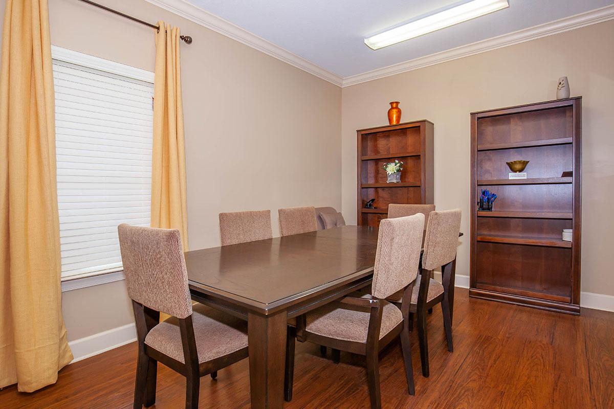 a living room filled with furniture and a wood floor