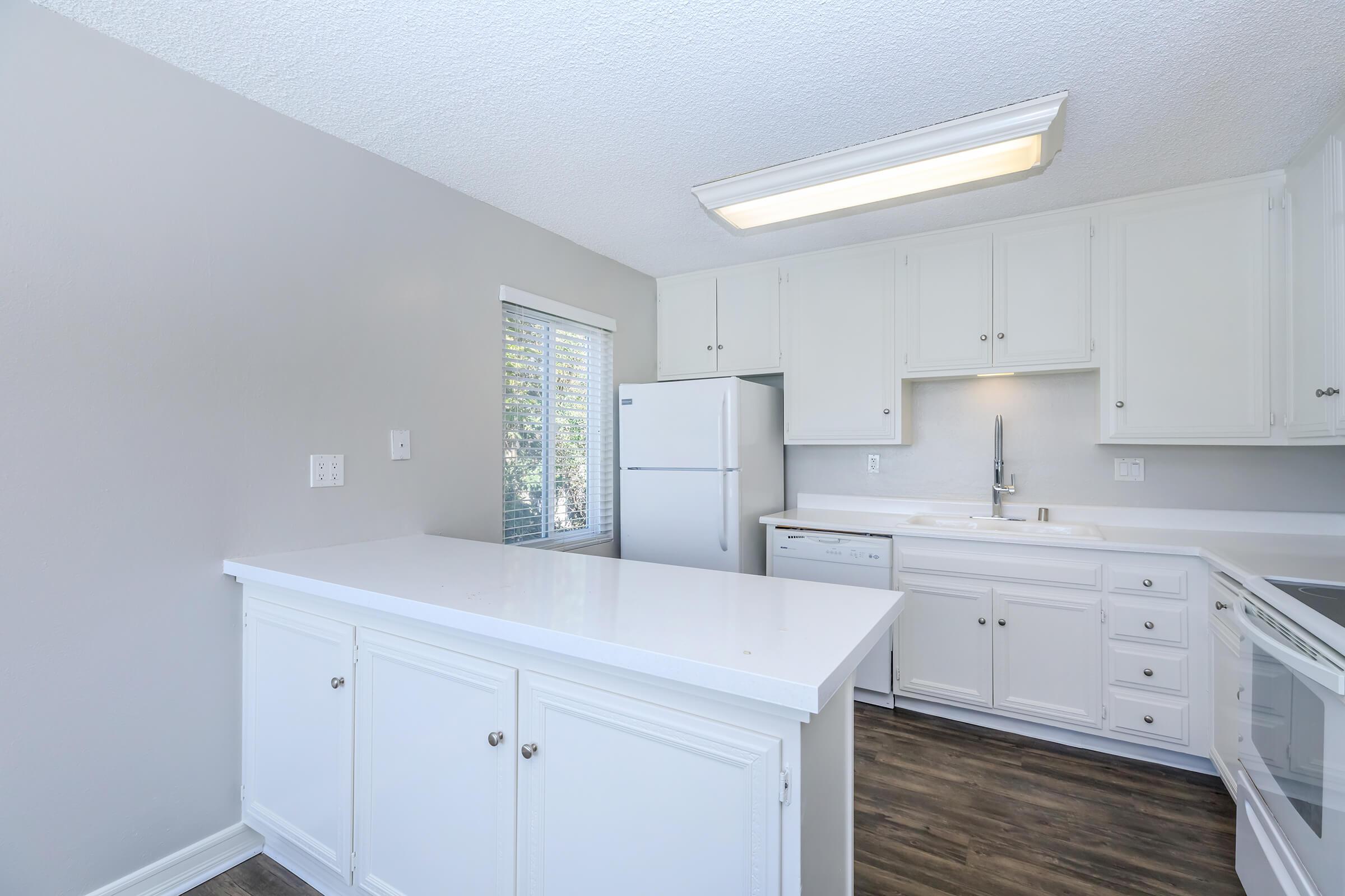 a kitchen with a sink and a refrigerator
