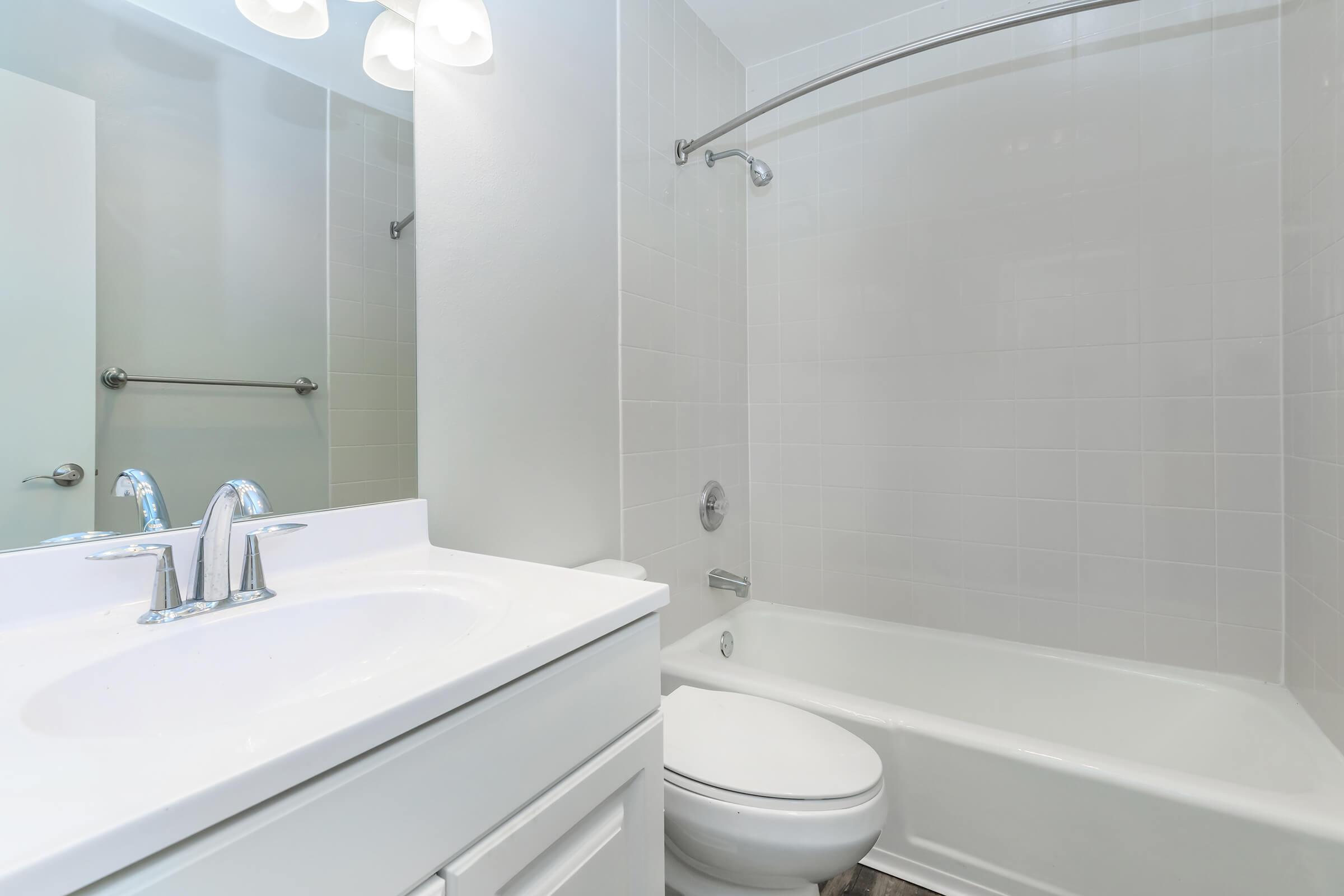 a large white tub sitting next to a sink