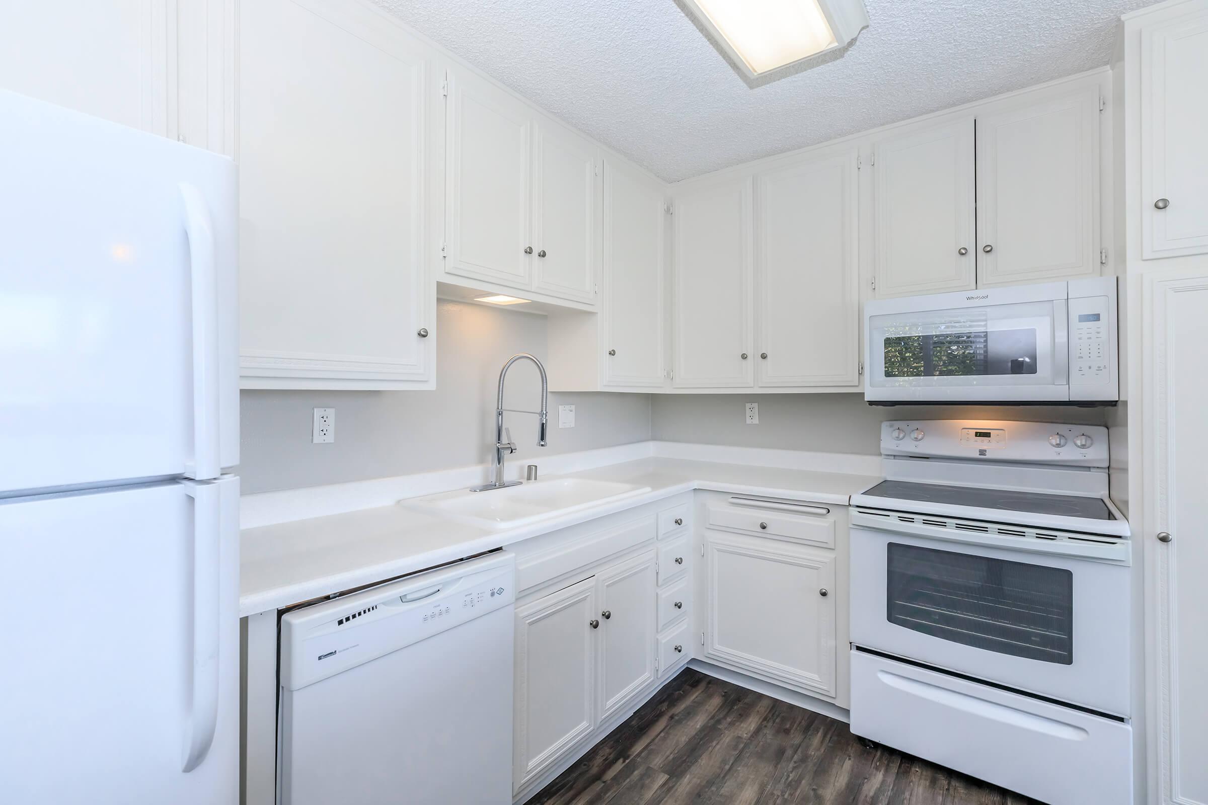 Two Bedroom Apartments in San Diego CA - Casa Del Norte Apartments - Elegant Kitchen with White Cabinetry and Countertops and All White Appliances