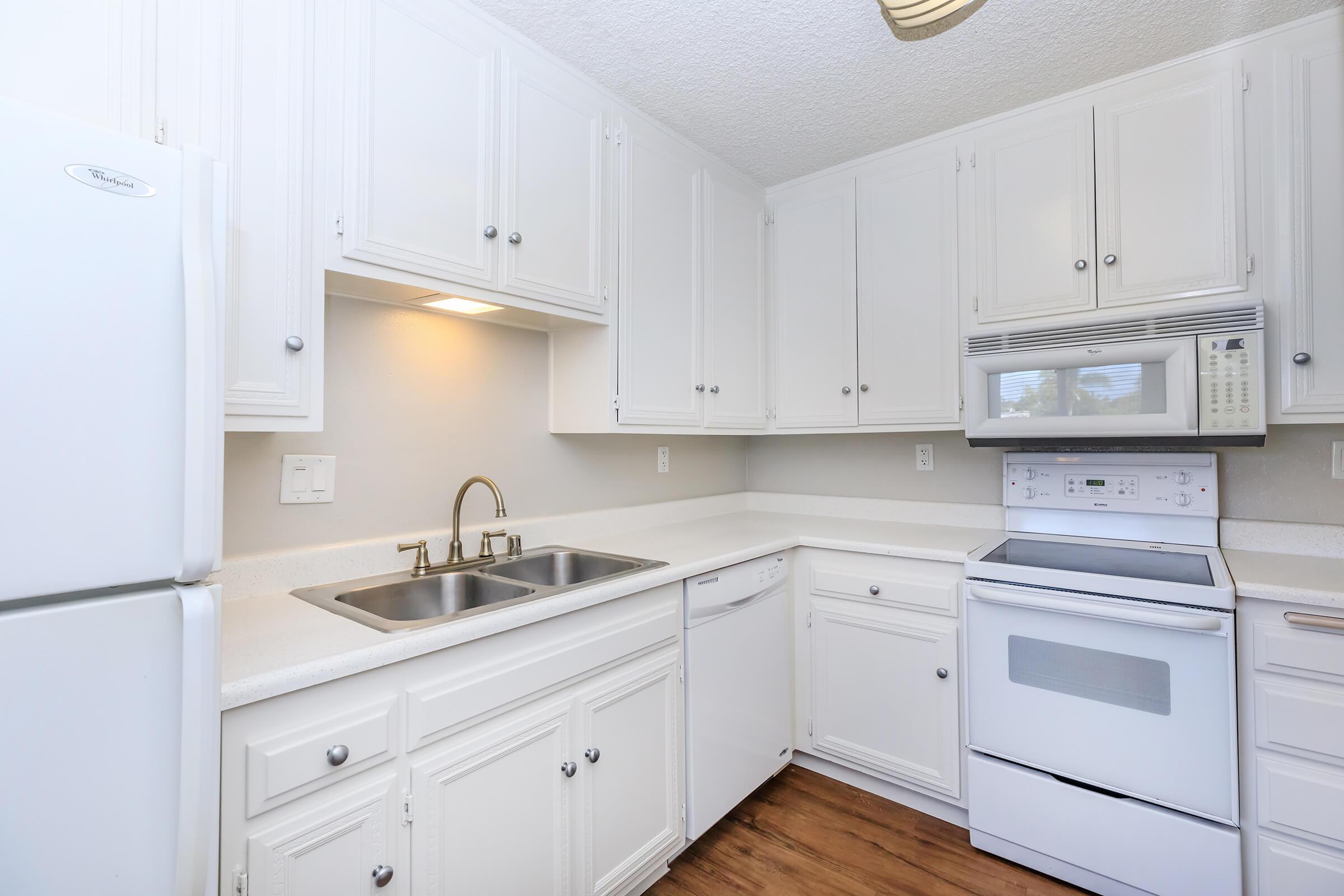 a white stove top oven sitting inside of a kitchen