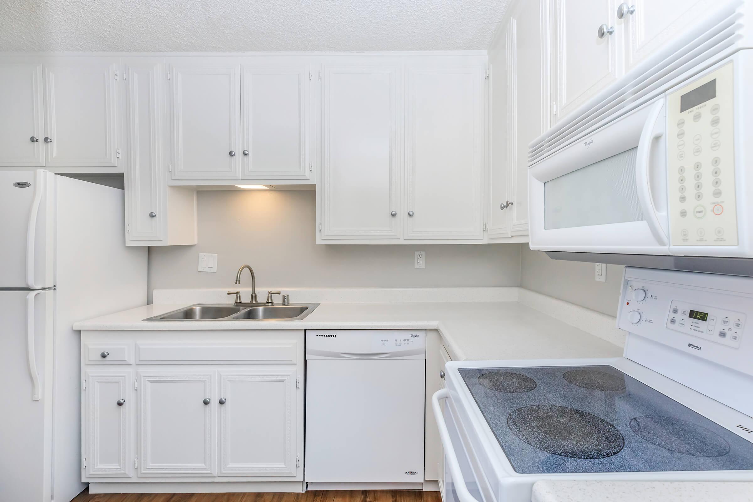a white stove top oven sitting inside of a kitchen