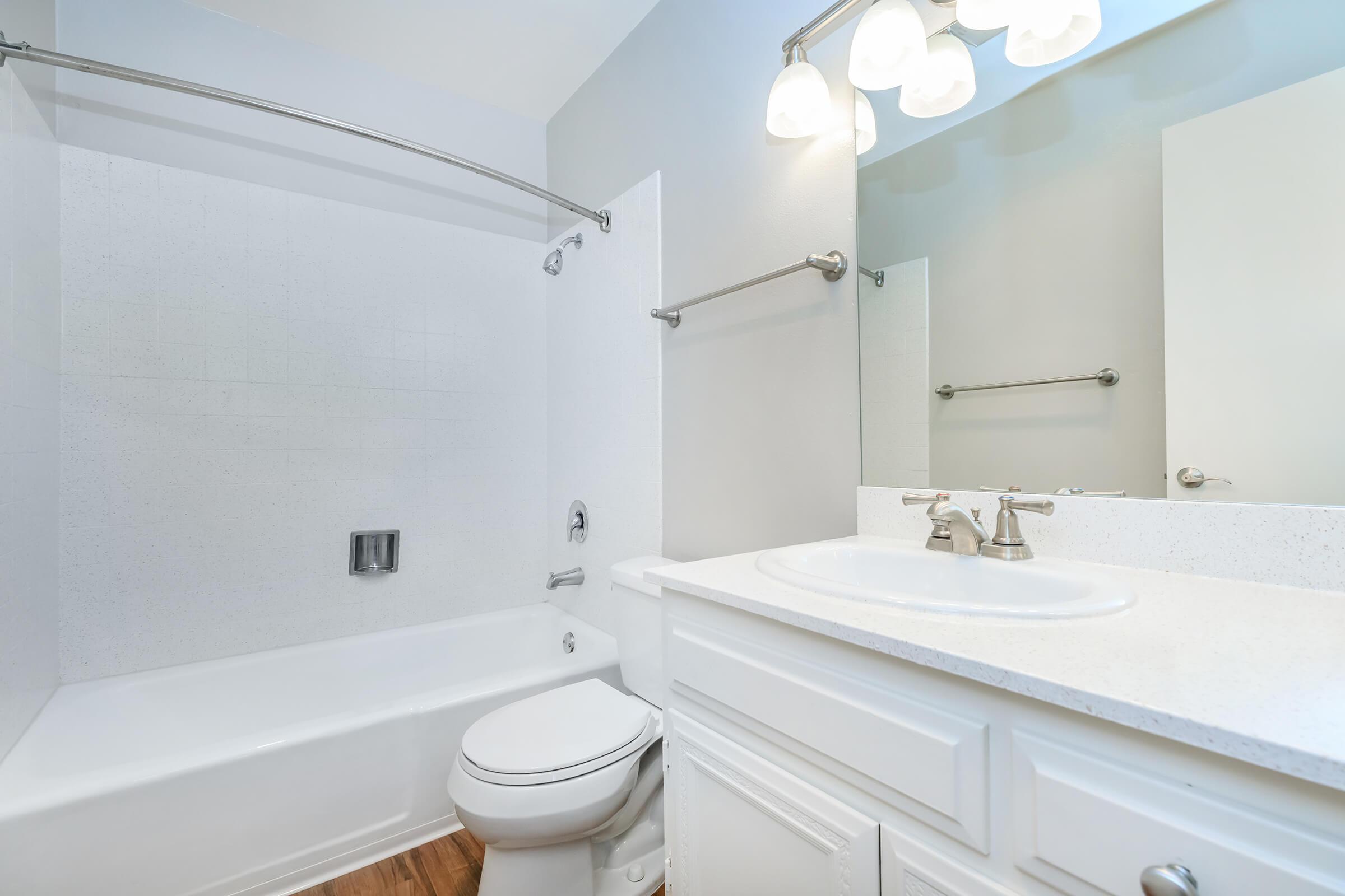 a white sink and a mirror