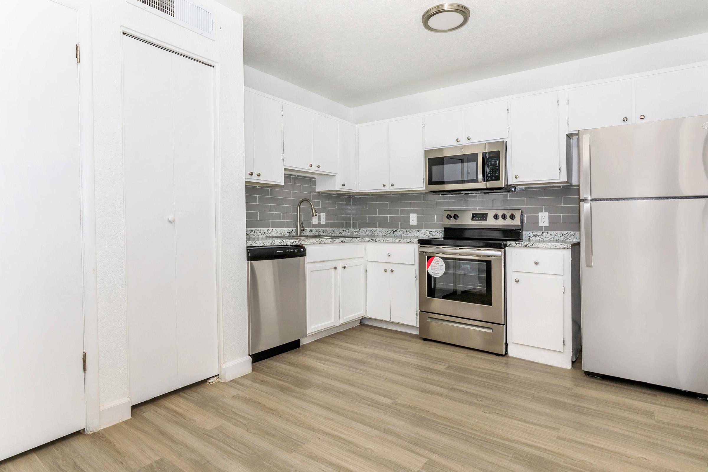 a kitchen with a stove and a refrigerator