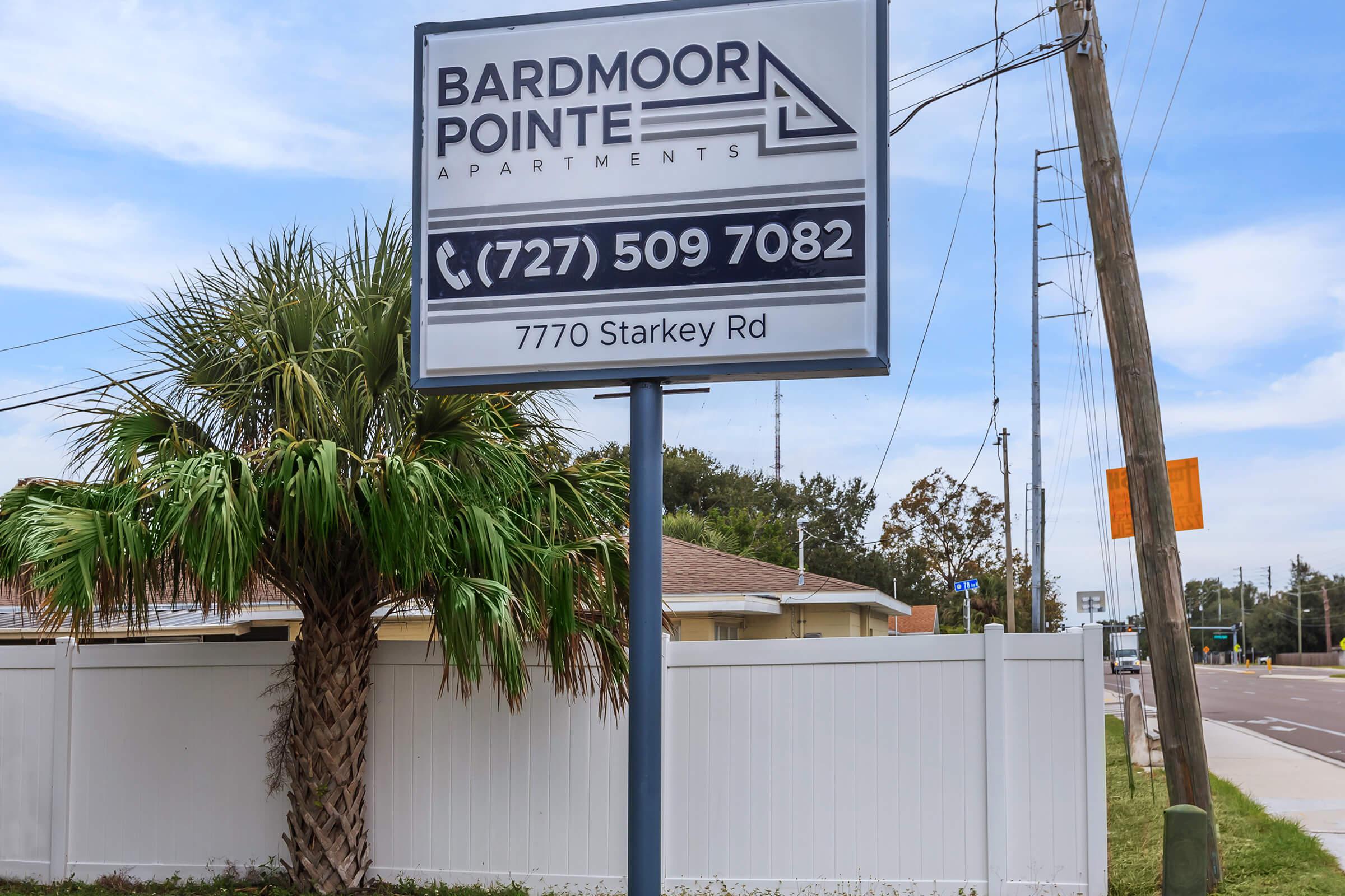 a pole that has a sign on the side of the street