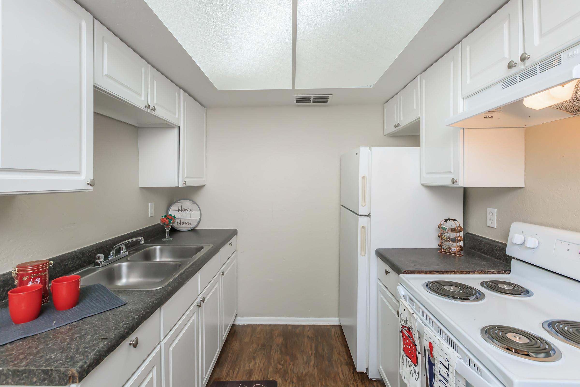 a kitchen with a stove sink and refrigerator