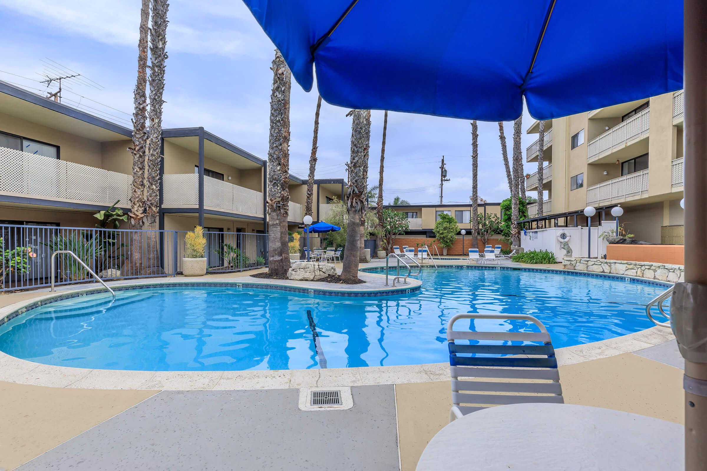 Newton Towers community pool with a blue umbrella