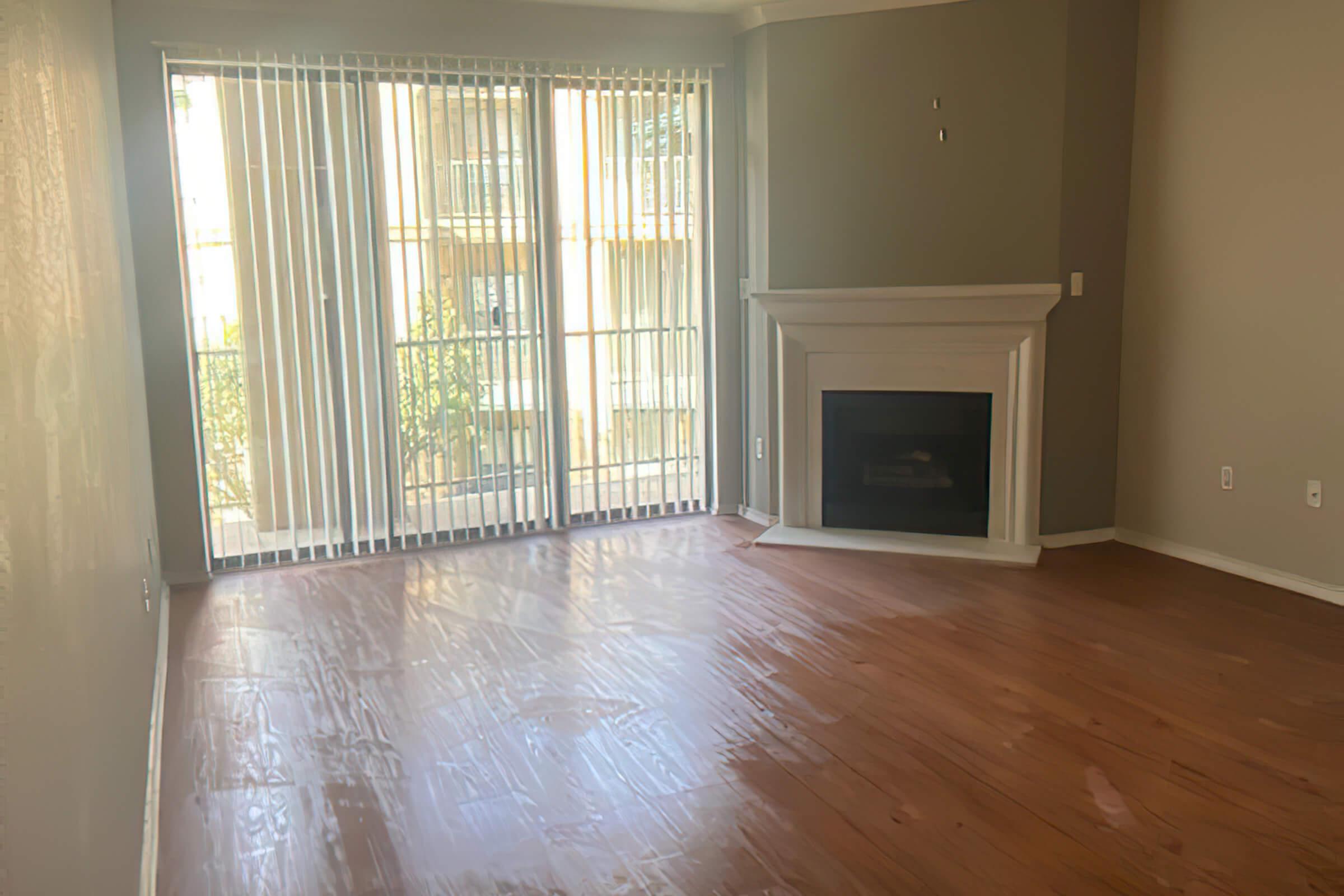 a view of a hard wood floor next to a window