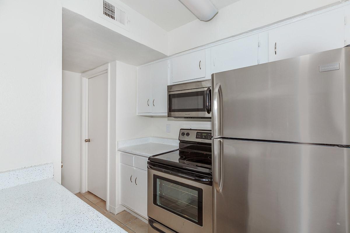 a kitchen with a stove top oven sitting inside of a refrigerator