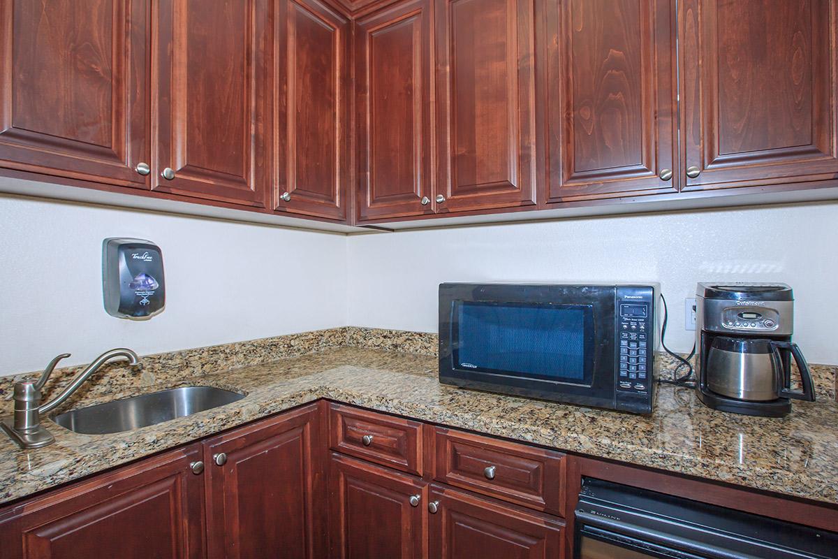 a kitchen with stainless steel appliances and wooden cabinets