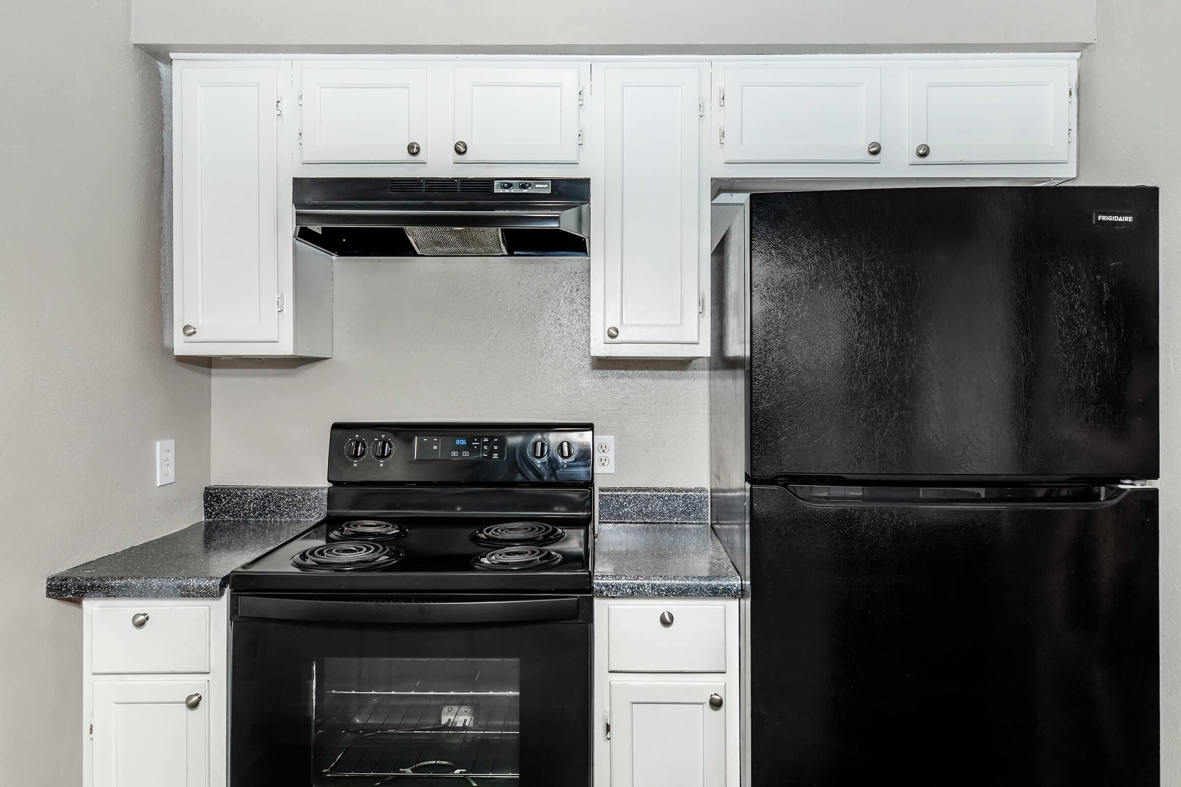 a kitchen with a stove top oven sitting inside of a refrigerator