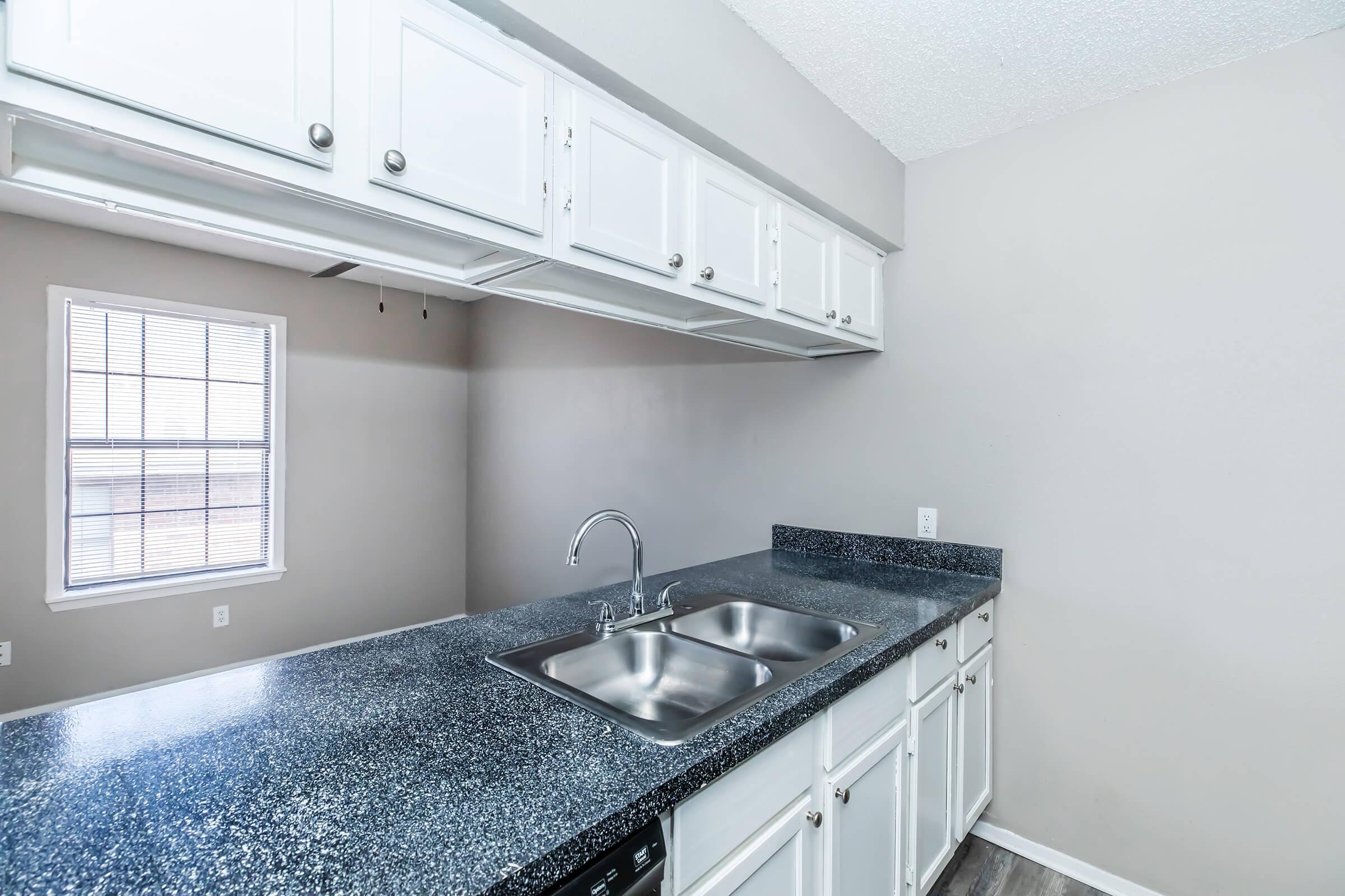 a kitchen with a sink and a window