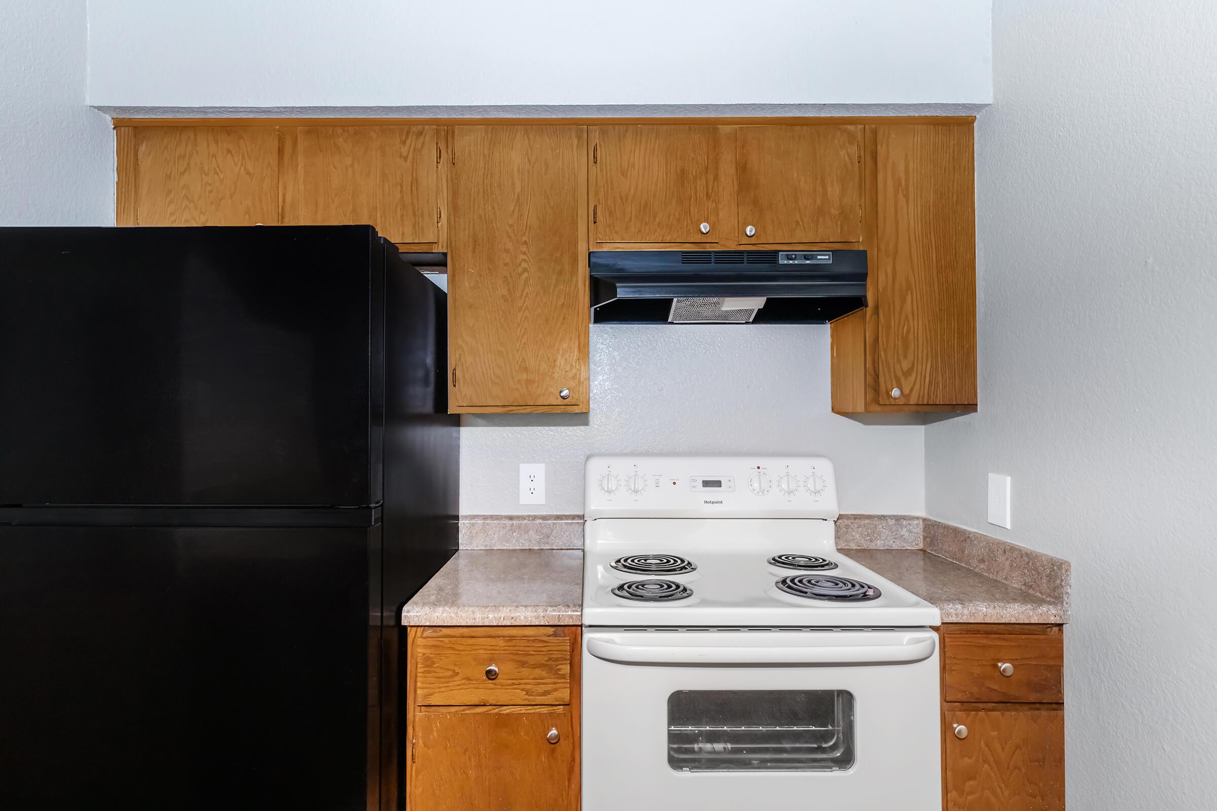 a kitchen with a stove top oven sitting inside of a refrigerator