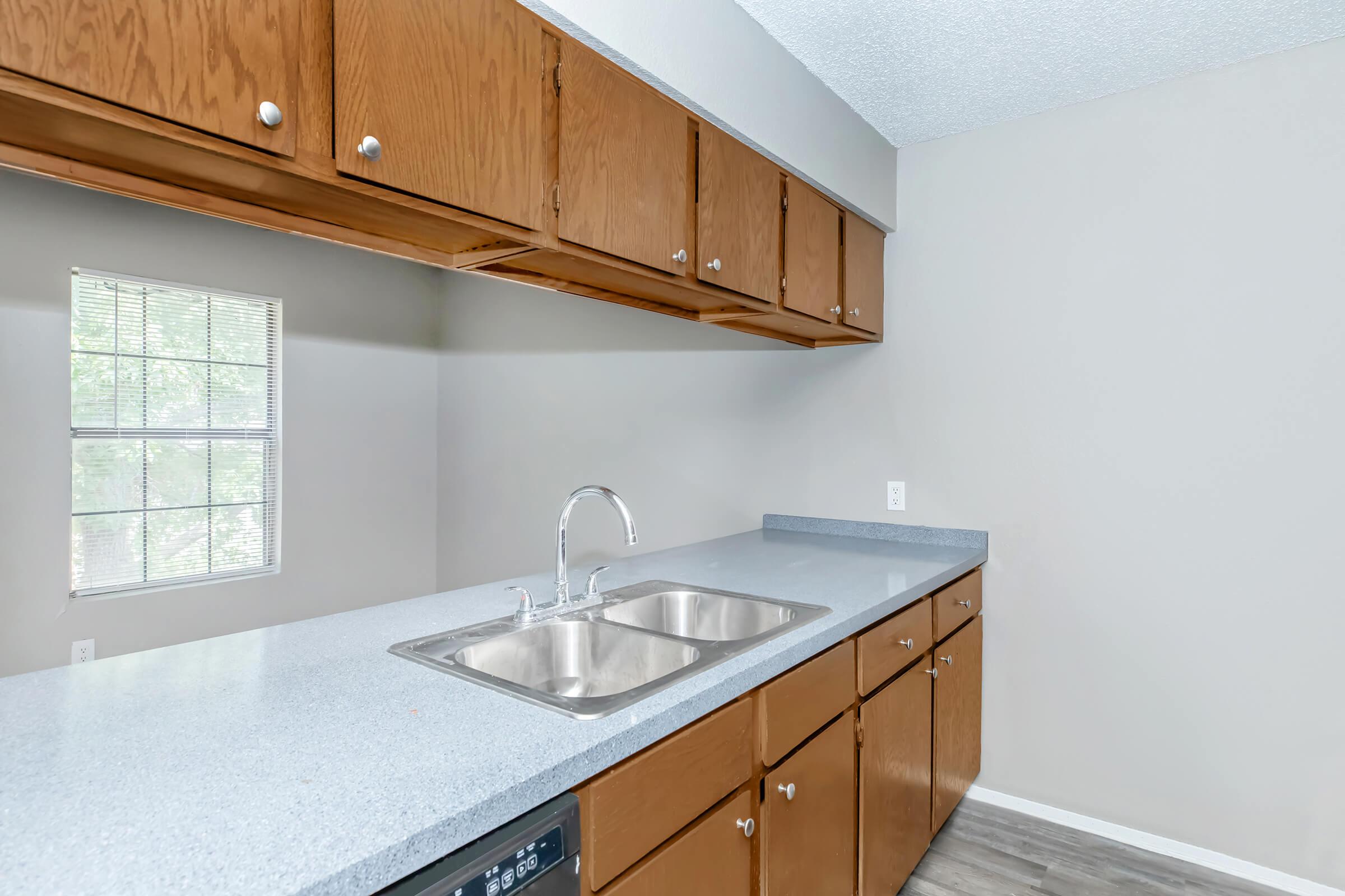 a kitchen with a sink and a window