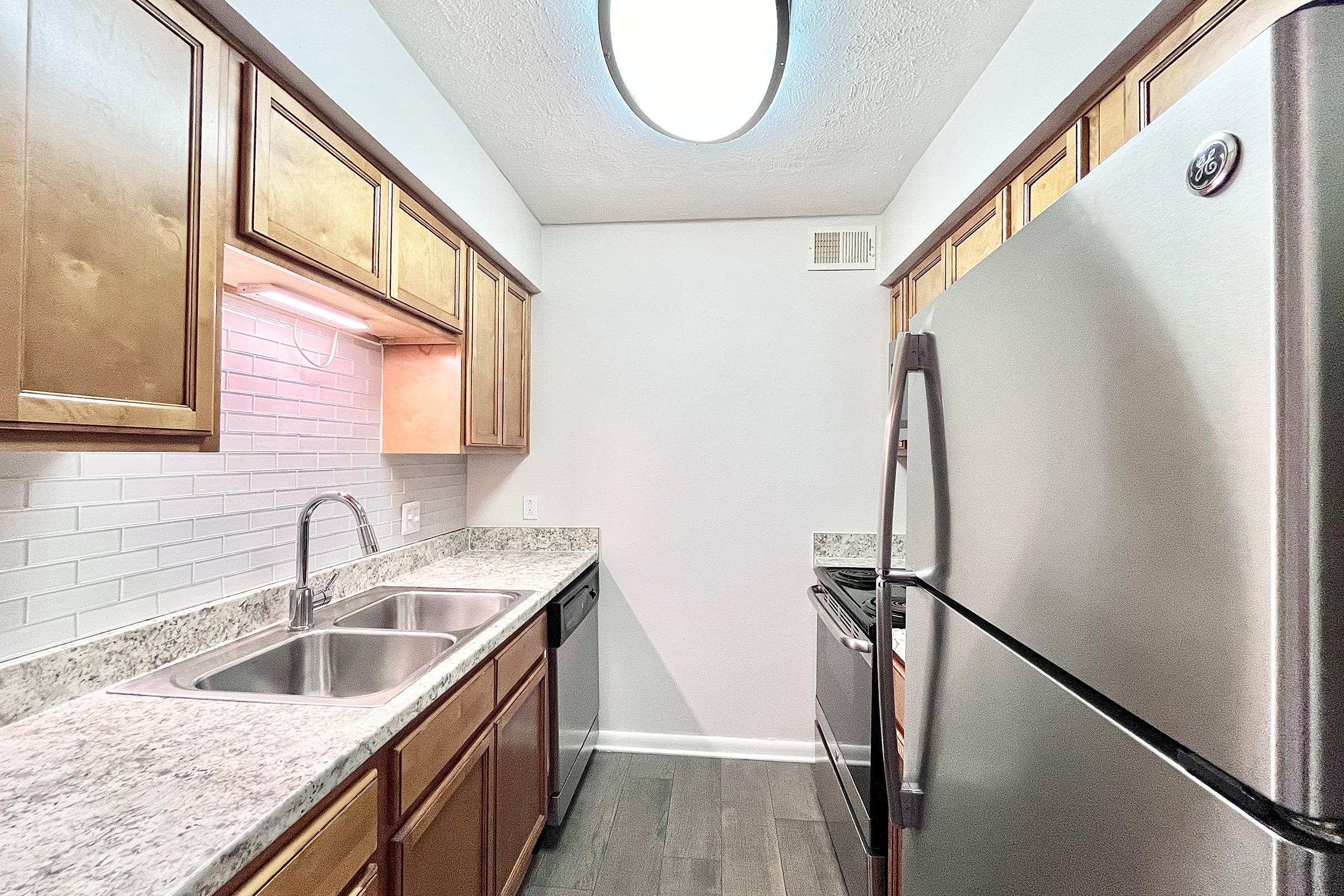 a kitchen with a sink and a mirror