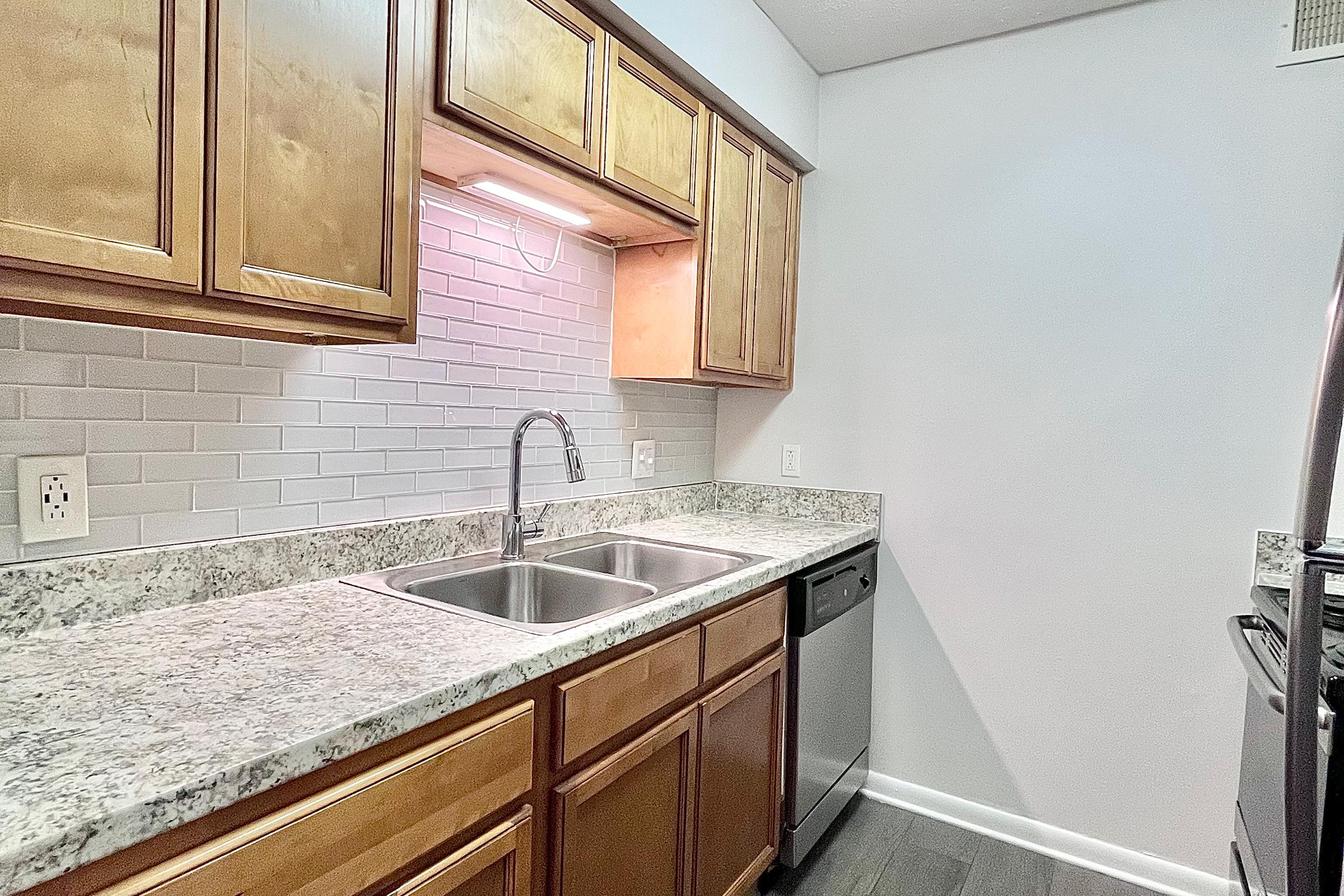 a kitchen with a sink and a mirror