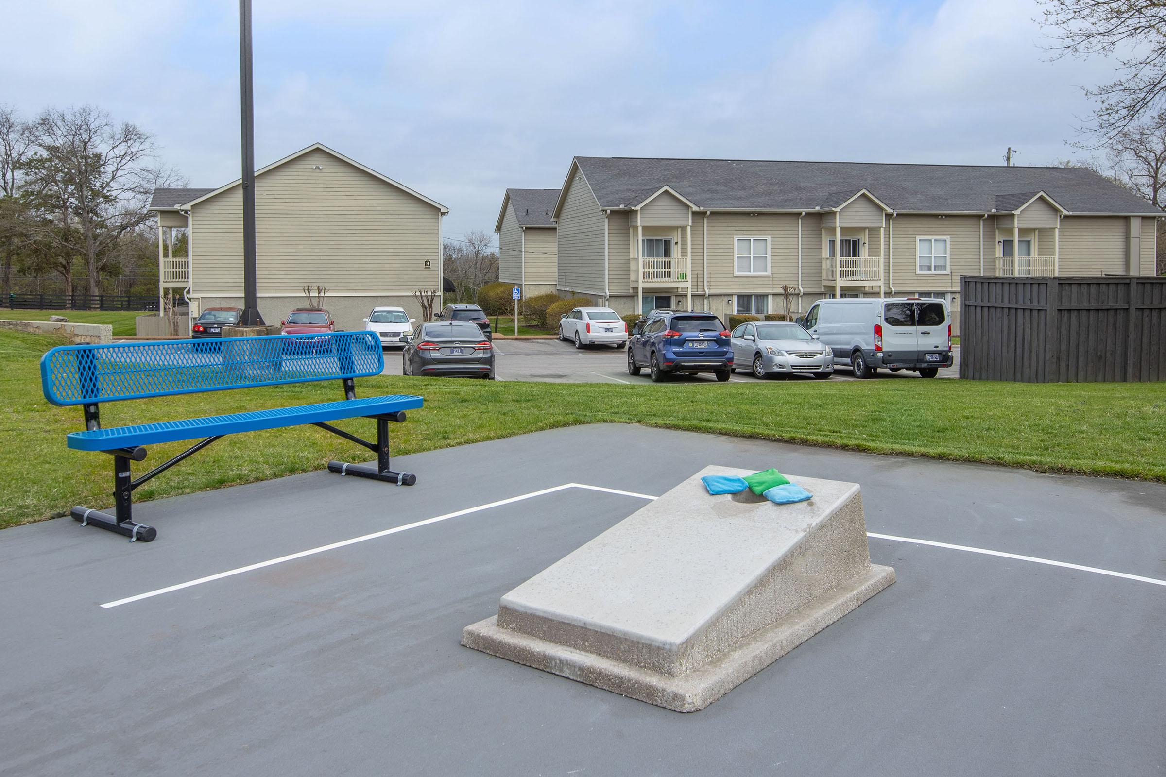 a bench is sitting in a parking lot