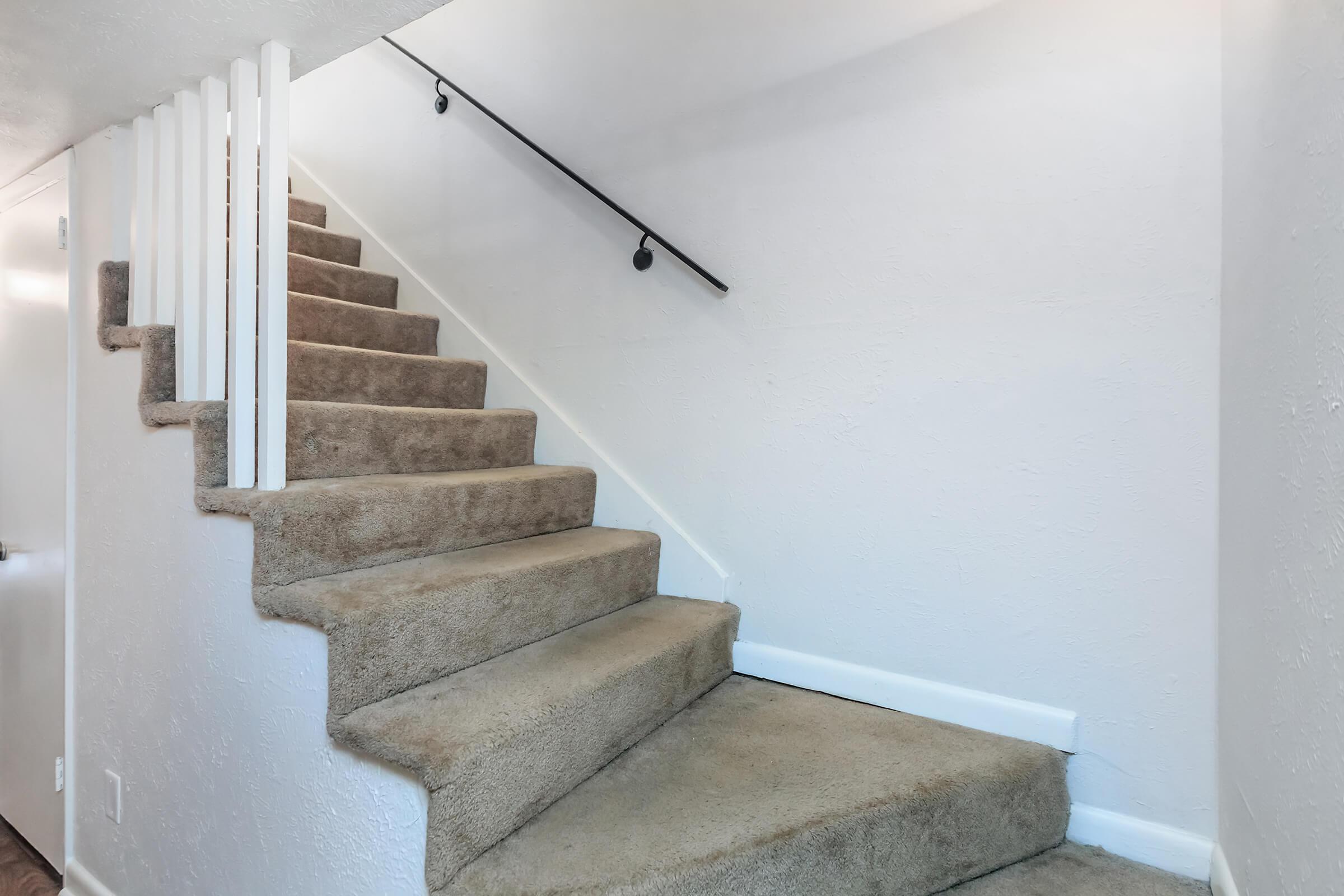 Carpeted staircase at Chase Cove Apartments