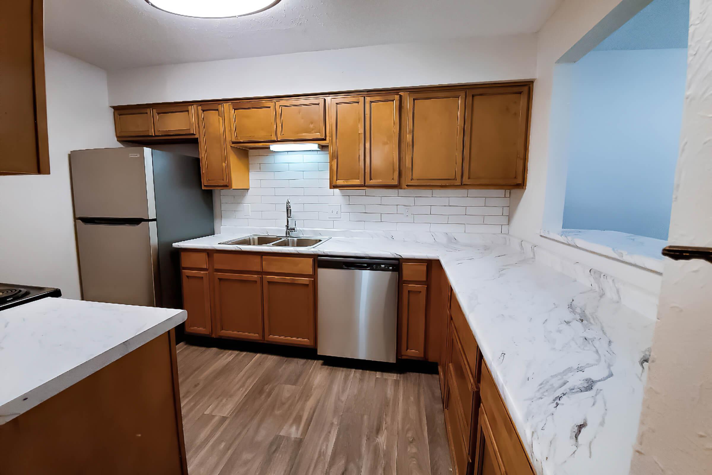 a kitchen with wooden cabinets