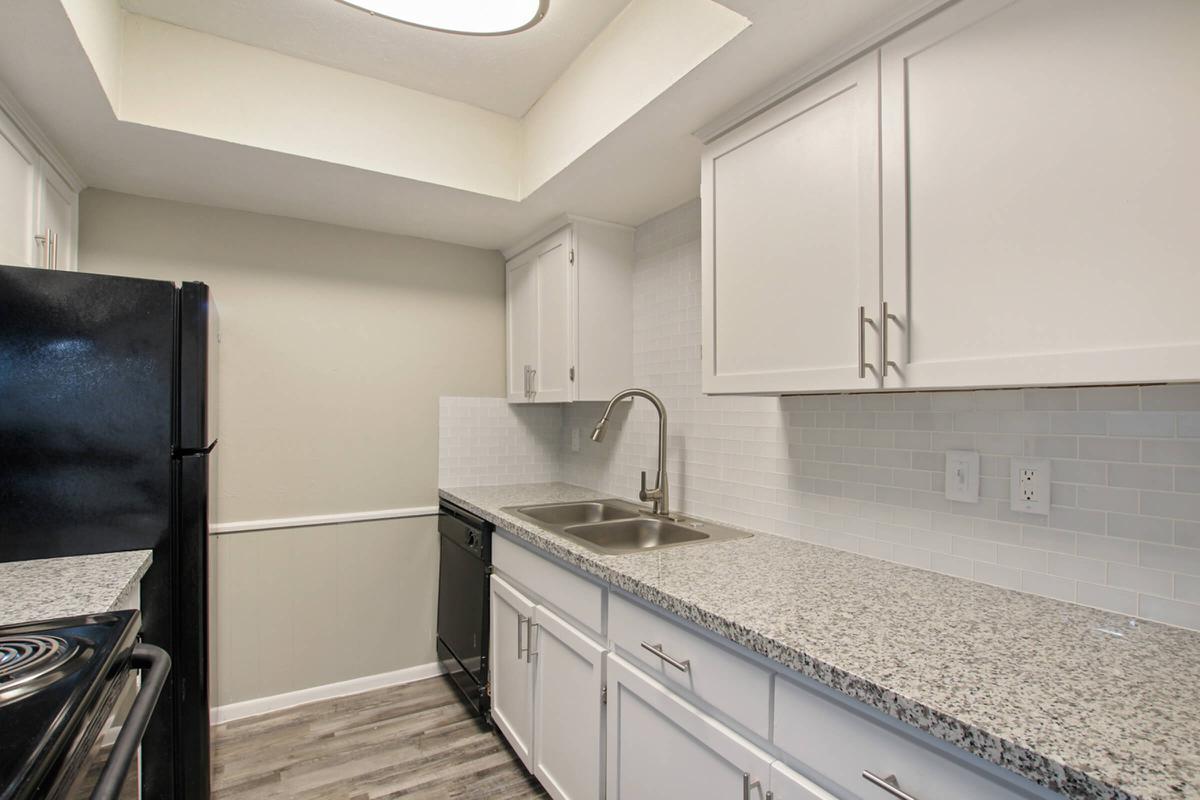 a kitchen with stainless steel appliances and wooden cabinets