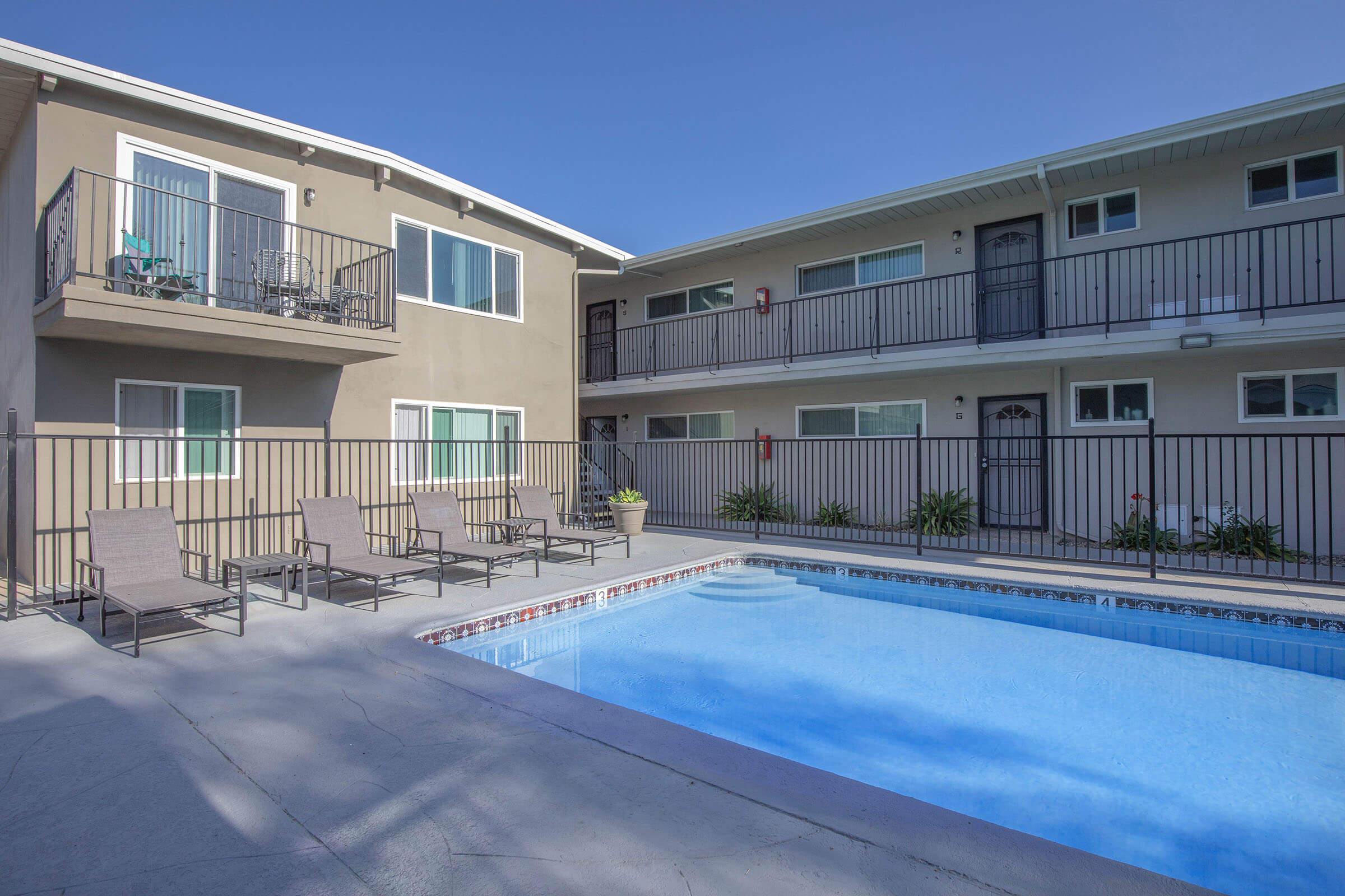 a house with a pool in front of a building