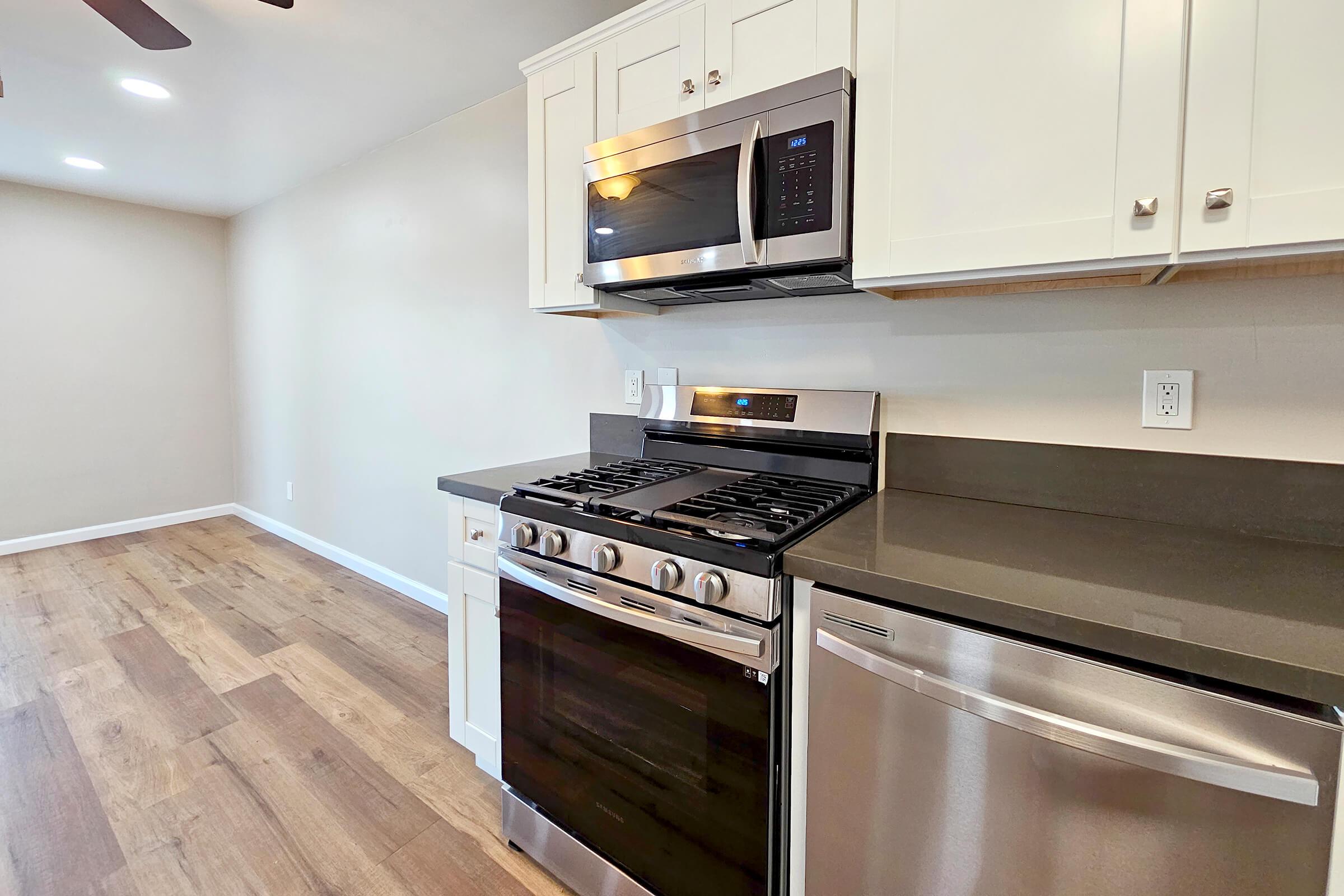 a stove top oven sitting inside of a kitchen