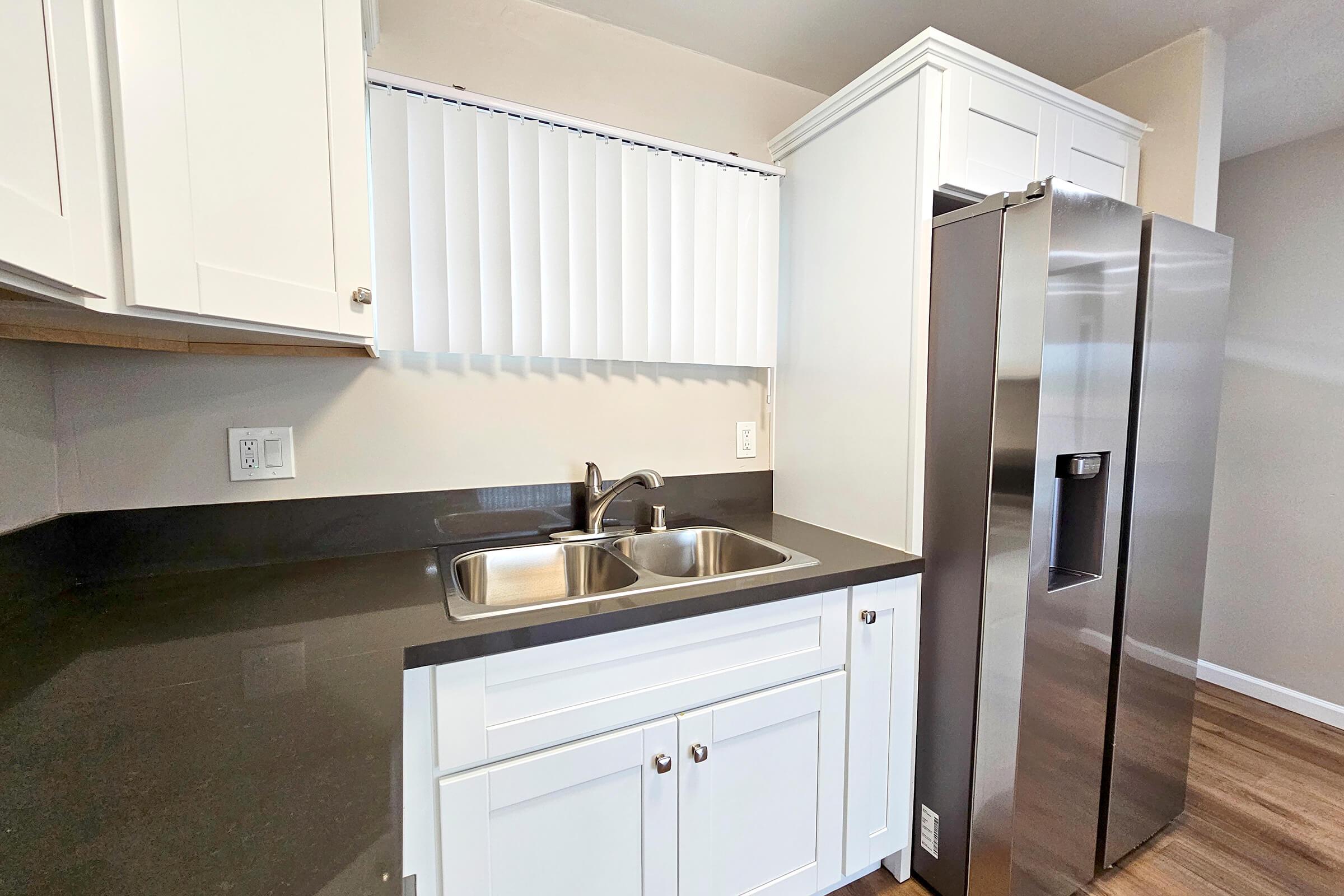 a kitchen with a sink and a mirror