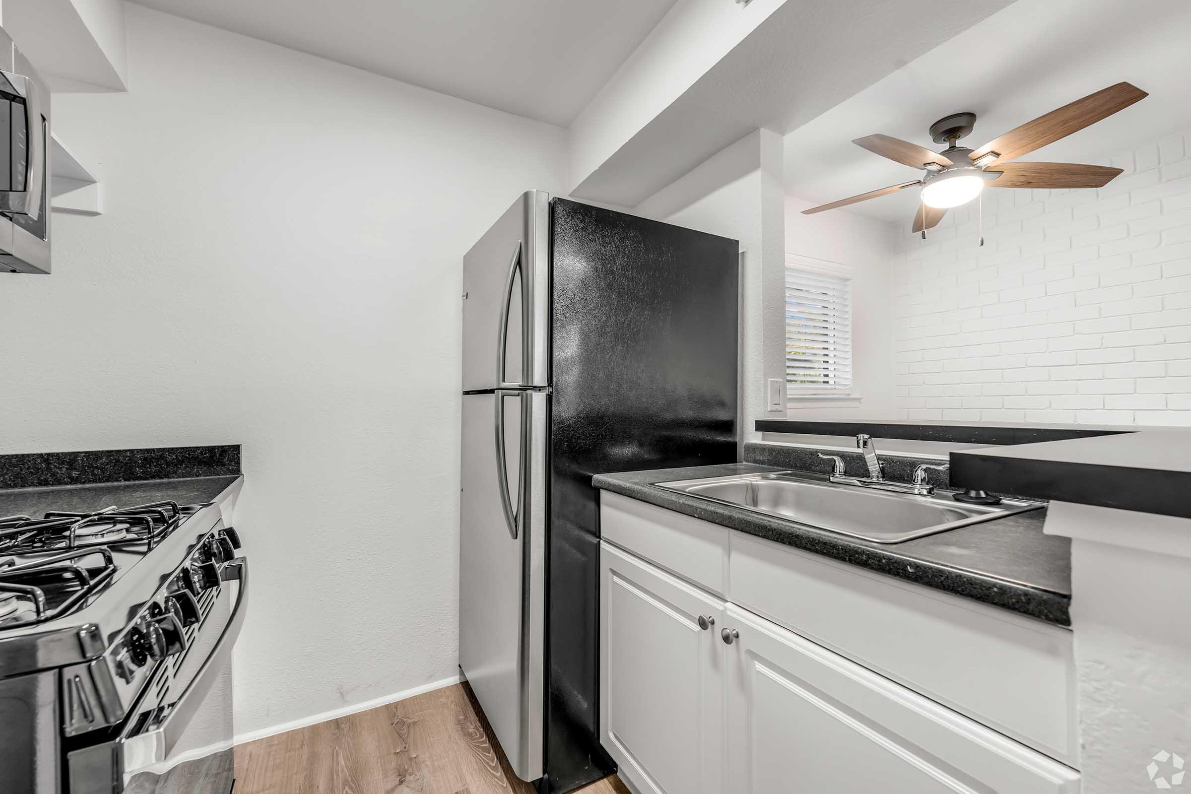 a kitchen with a stove and a refrigerator