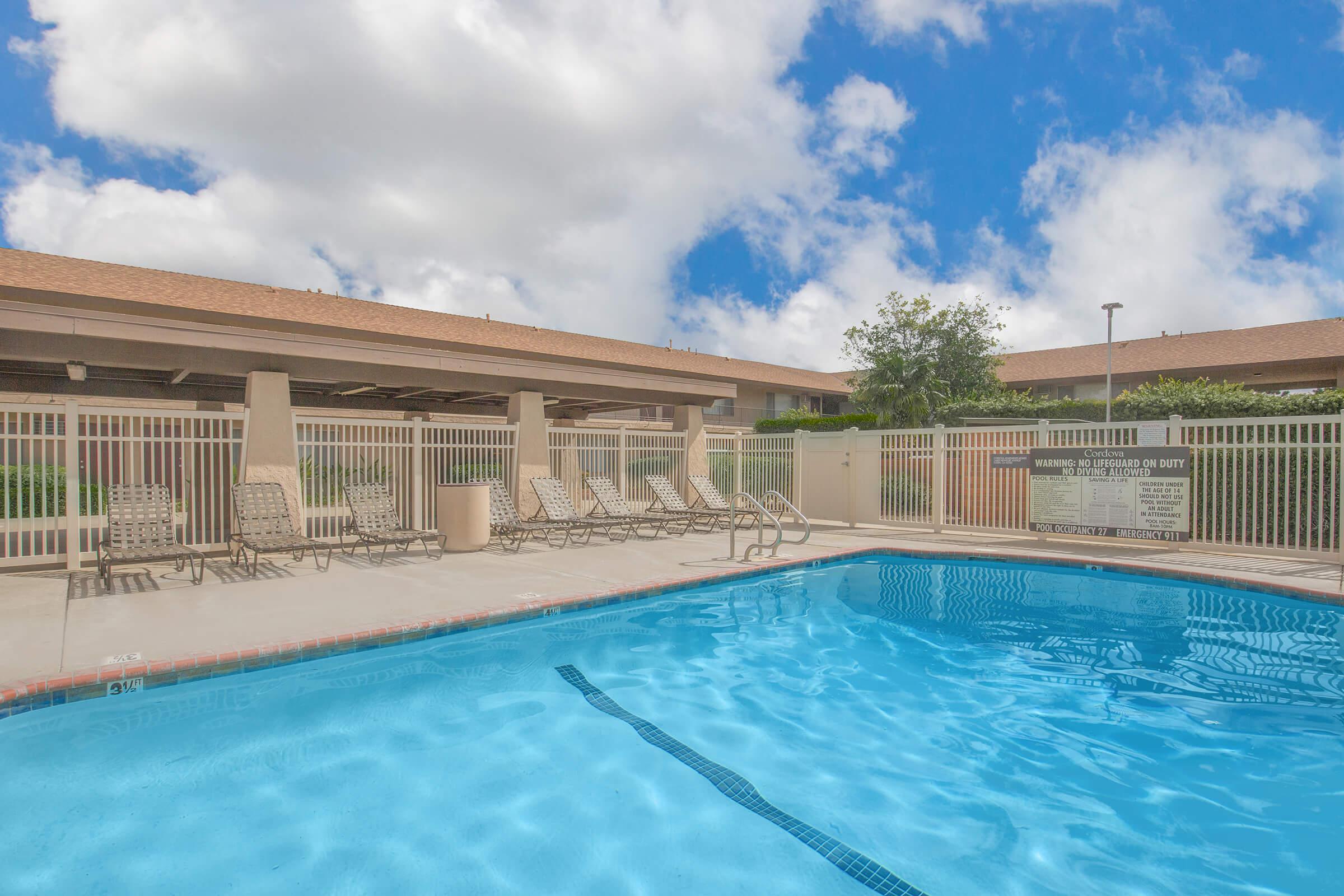 Castilian and Cordova Apartment Homes community pool with chairs