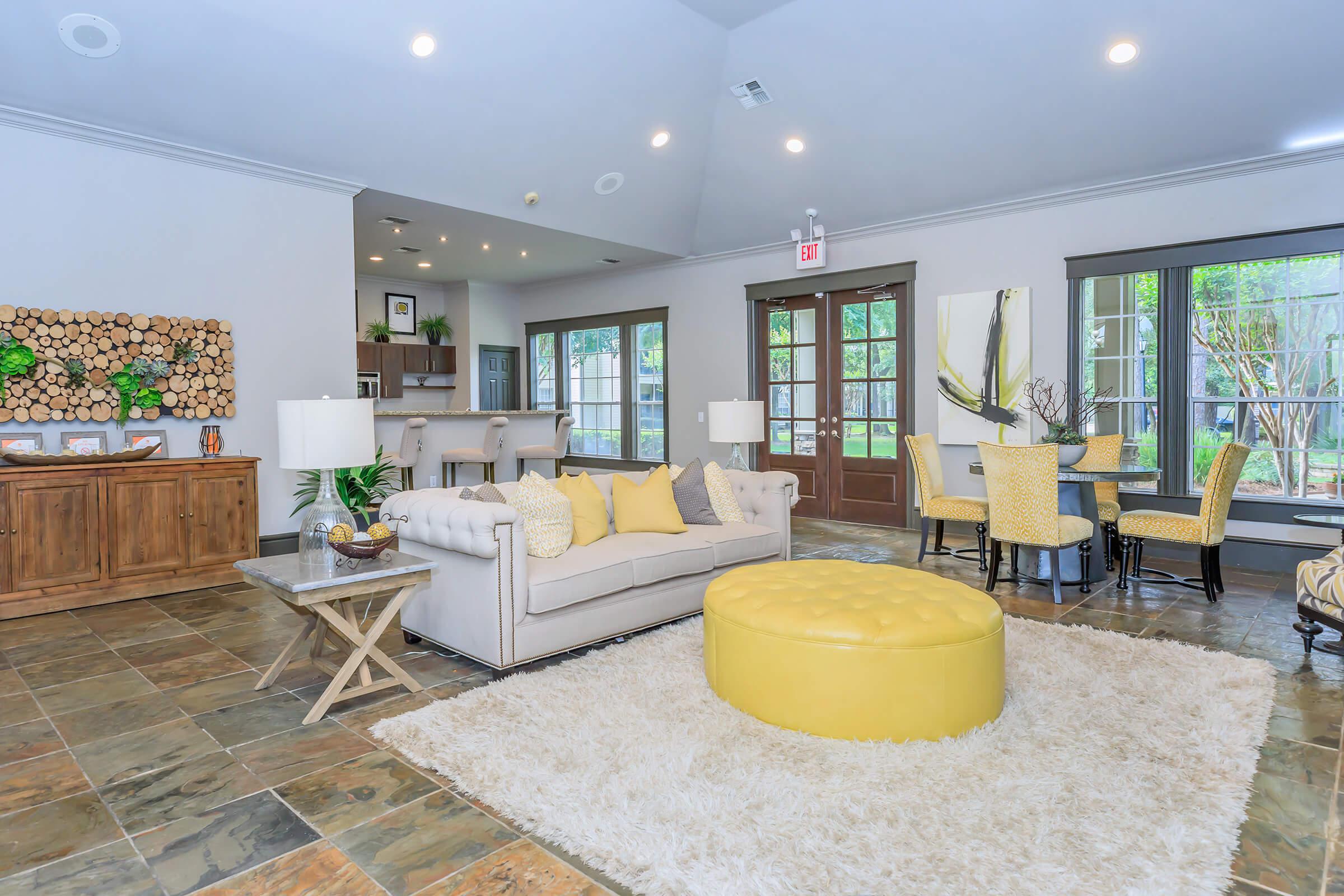 a living room filled with furniture and a large window