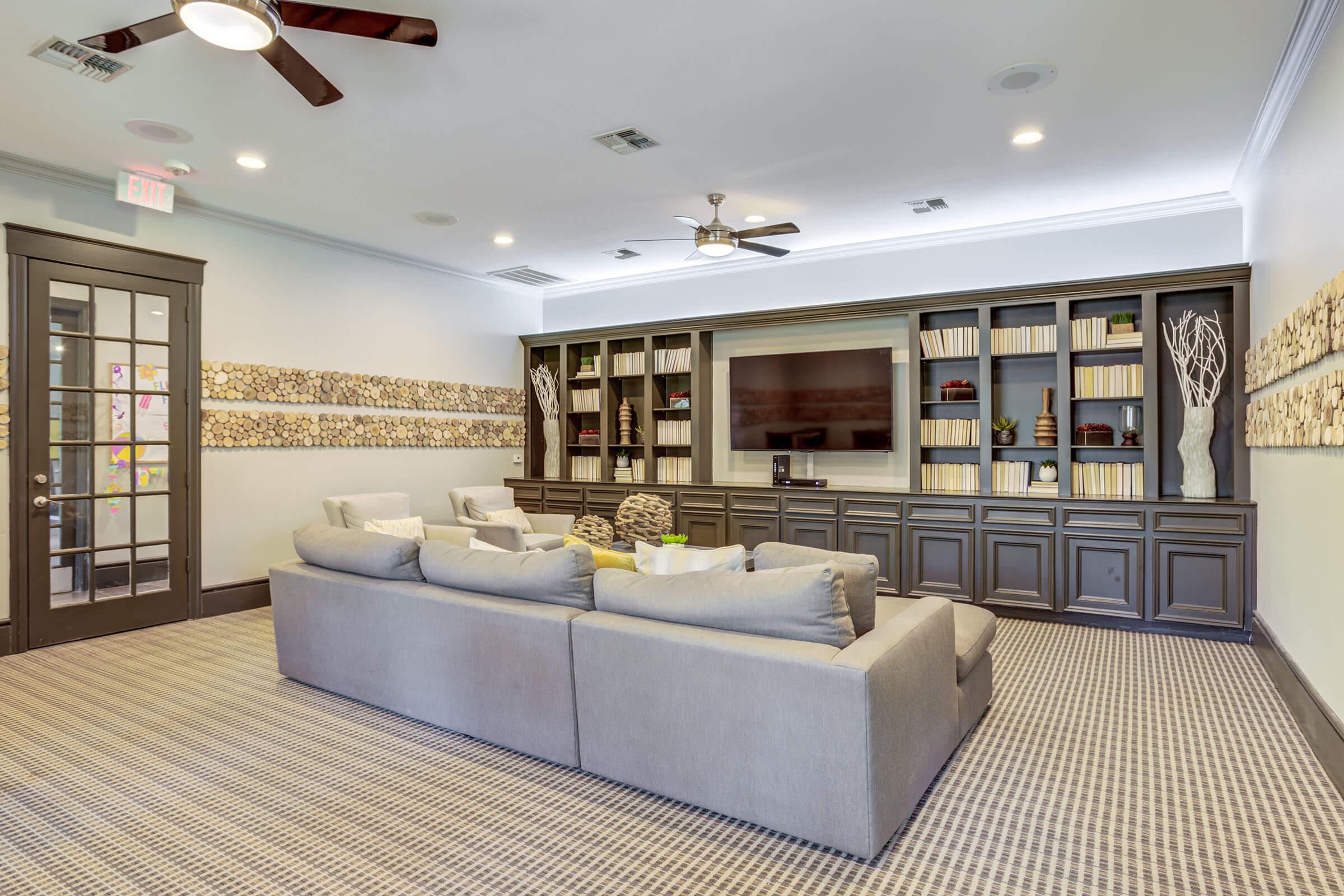 a living room filled with furniture and a large window