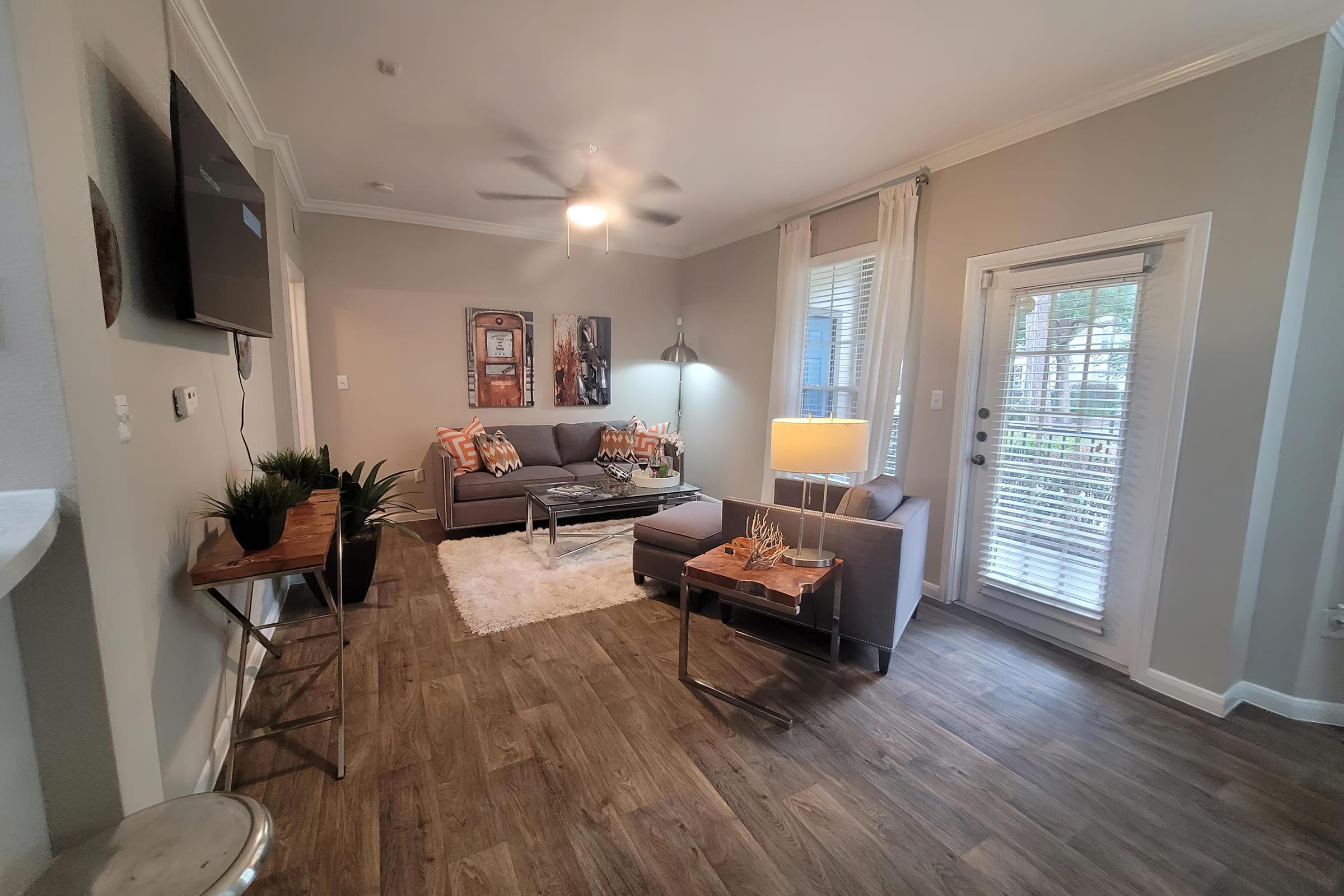 a living room filled with furniture and a large window