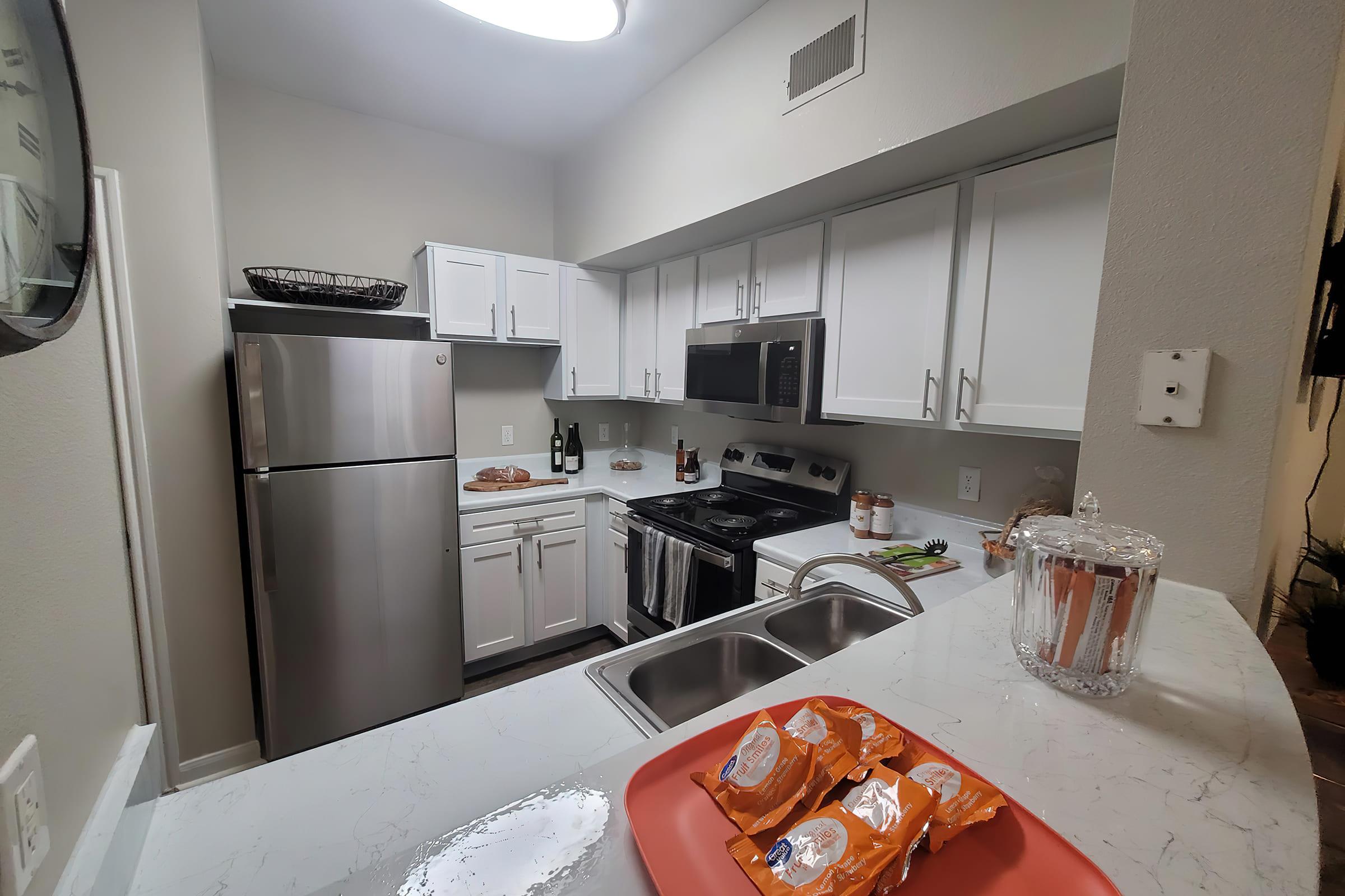 a kitchen with a sink and a mirror