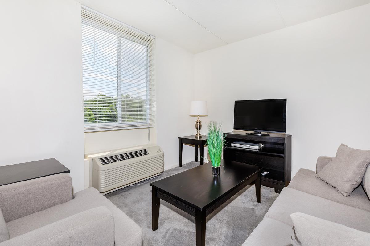 a living room filled with furniture and a large window