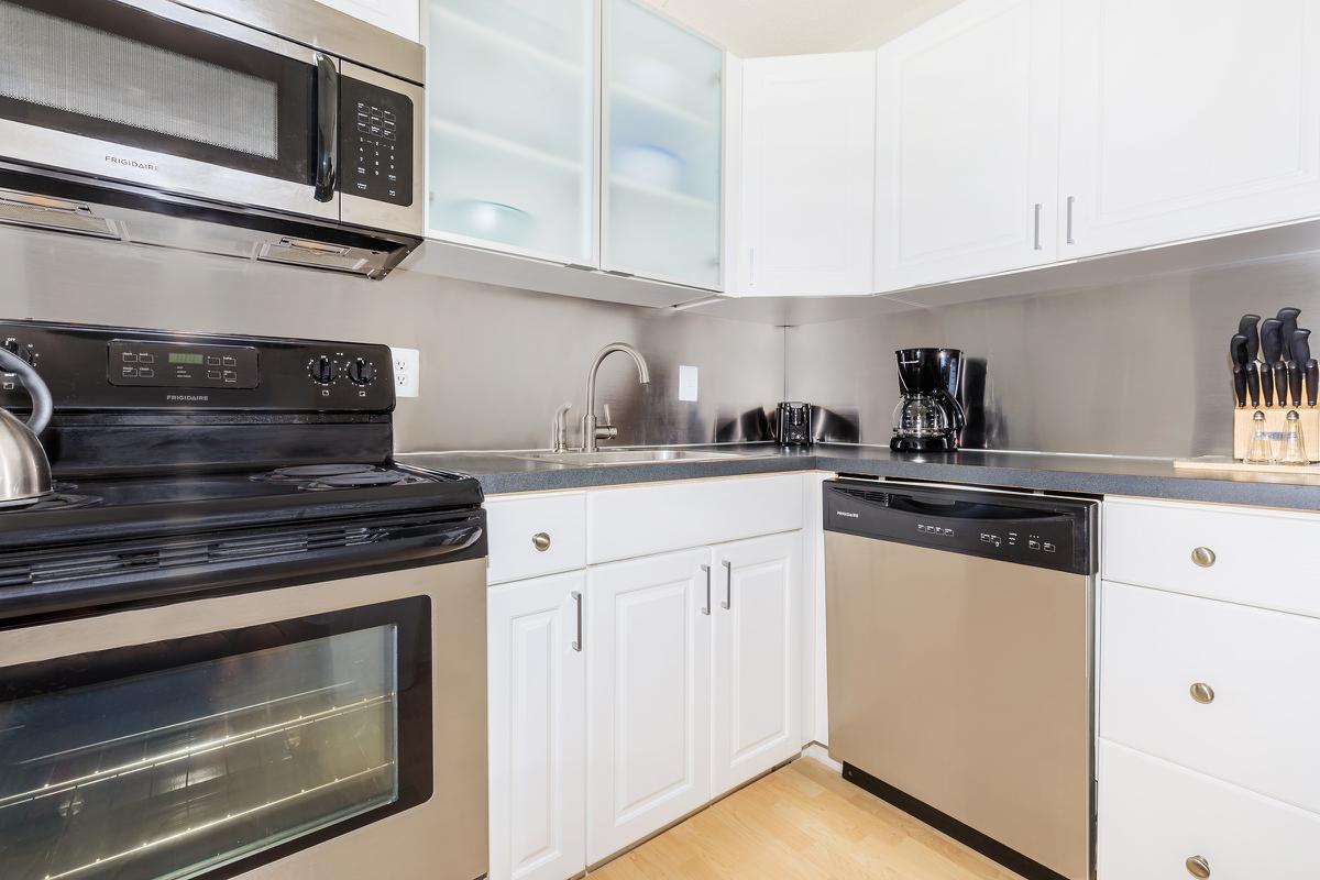 a stove top oven sitting inside of a kitchen