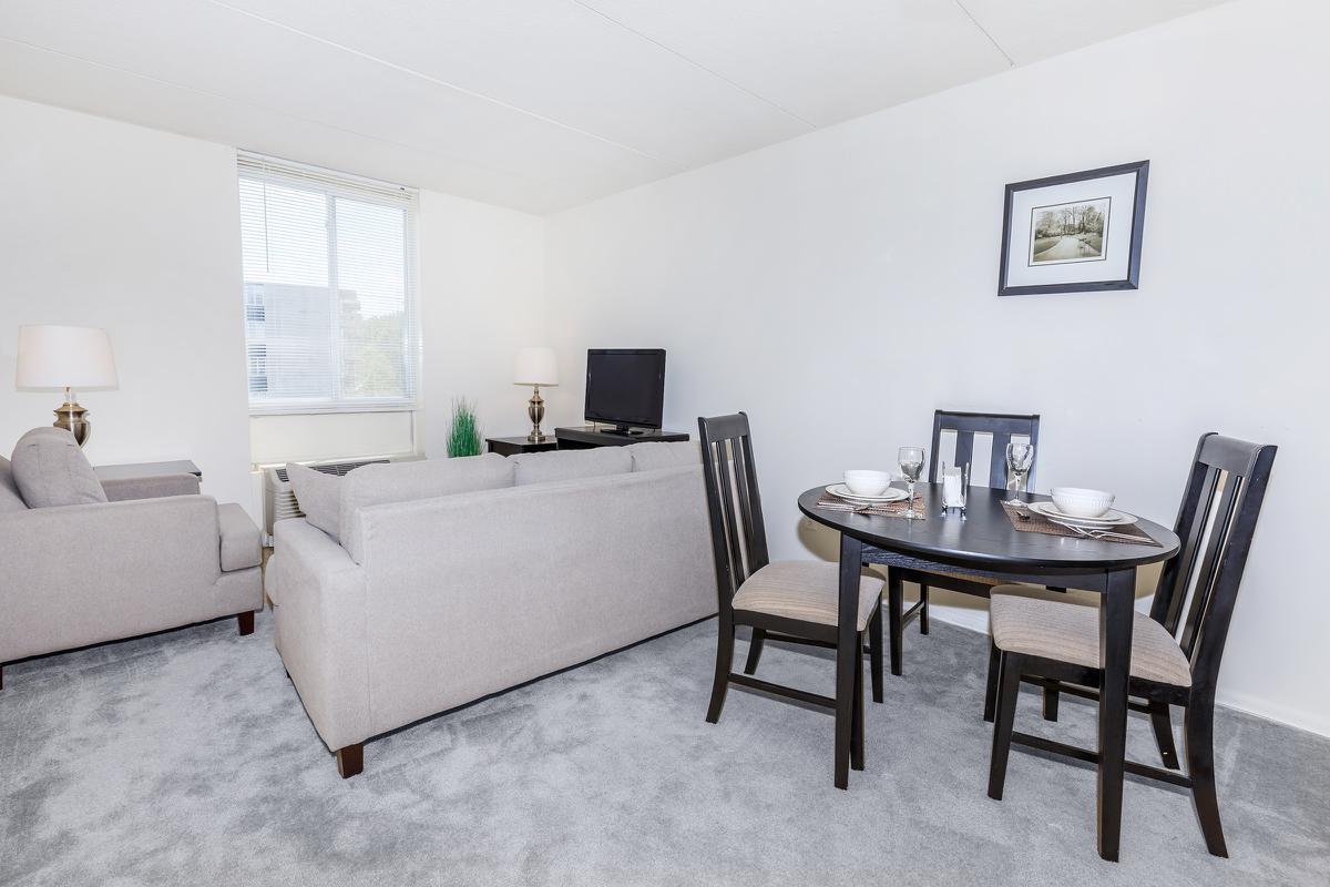 a bedroom with a bed and a chair in a room