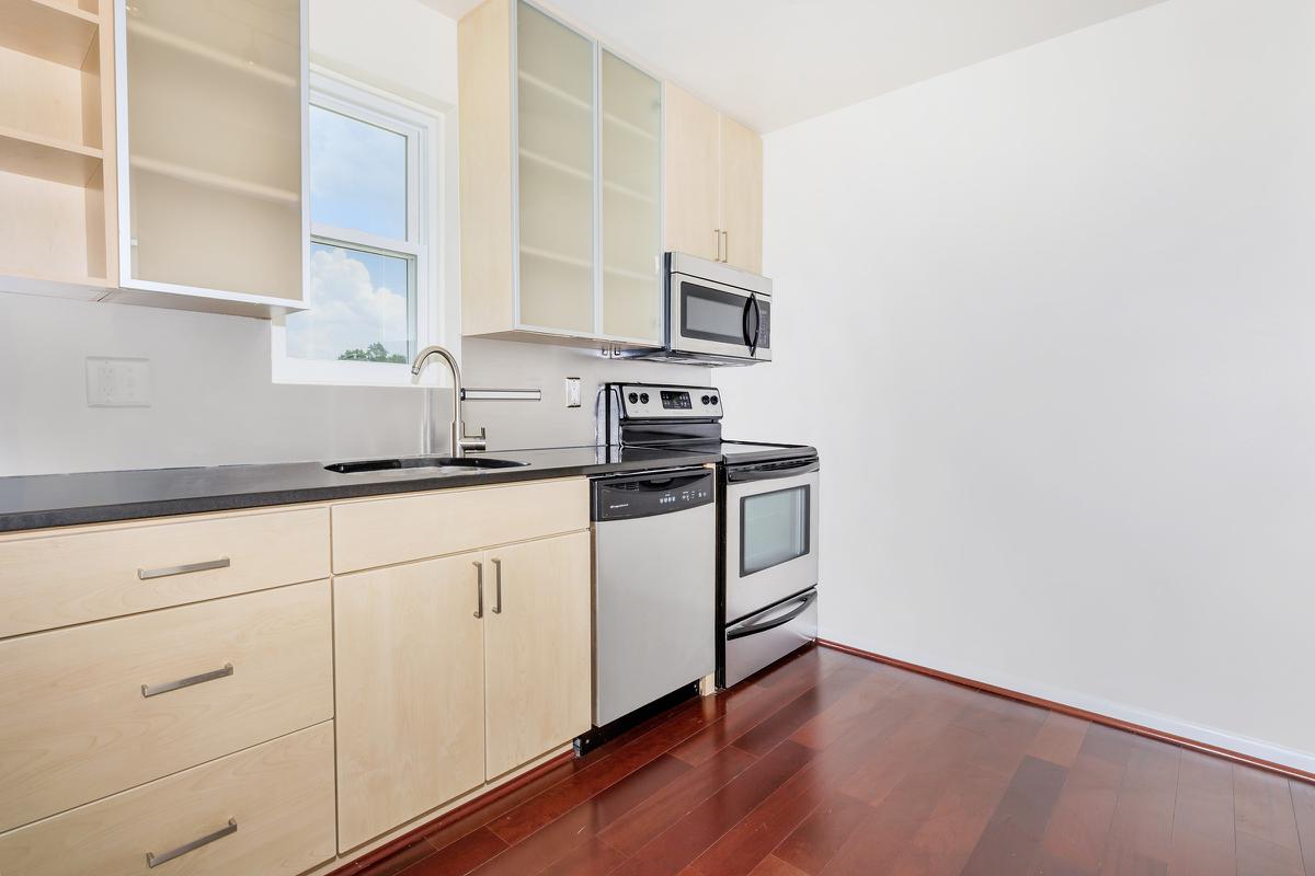 a stove top oven sitting inside of a kitchen