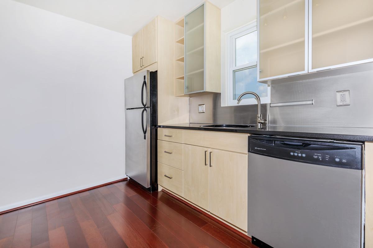 a stove top oven sitting inside of a kitchen