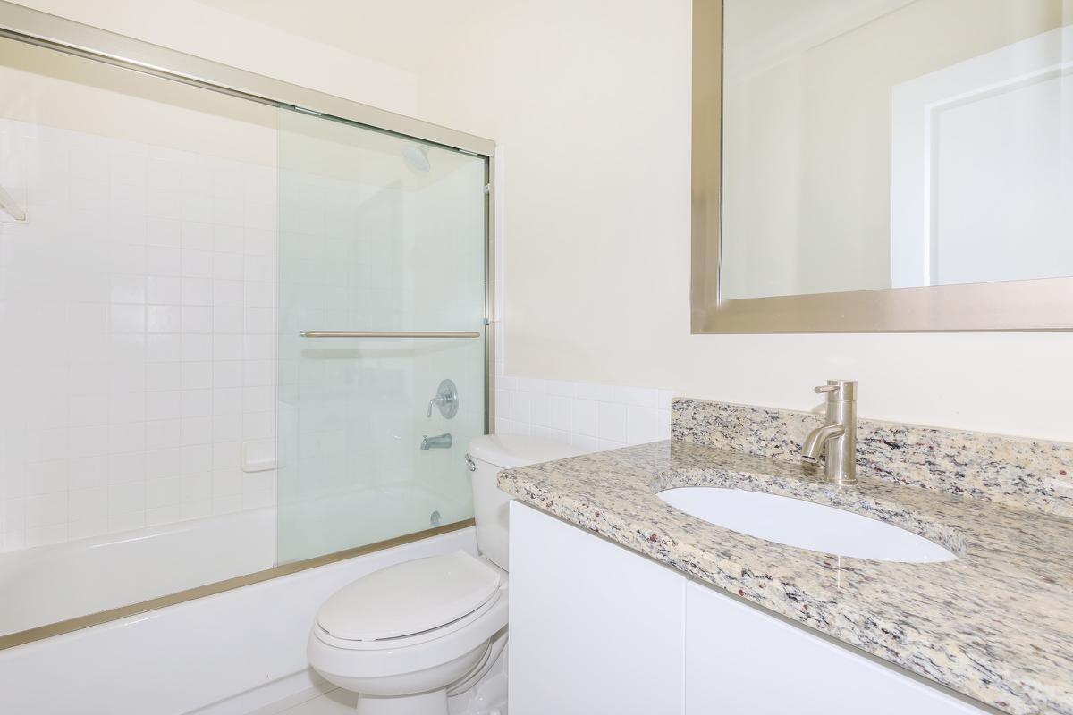 a large white tub next to a sink