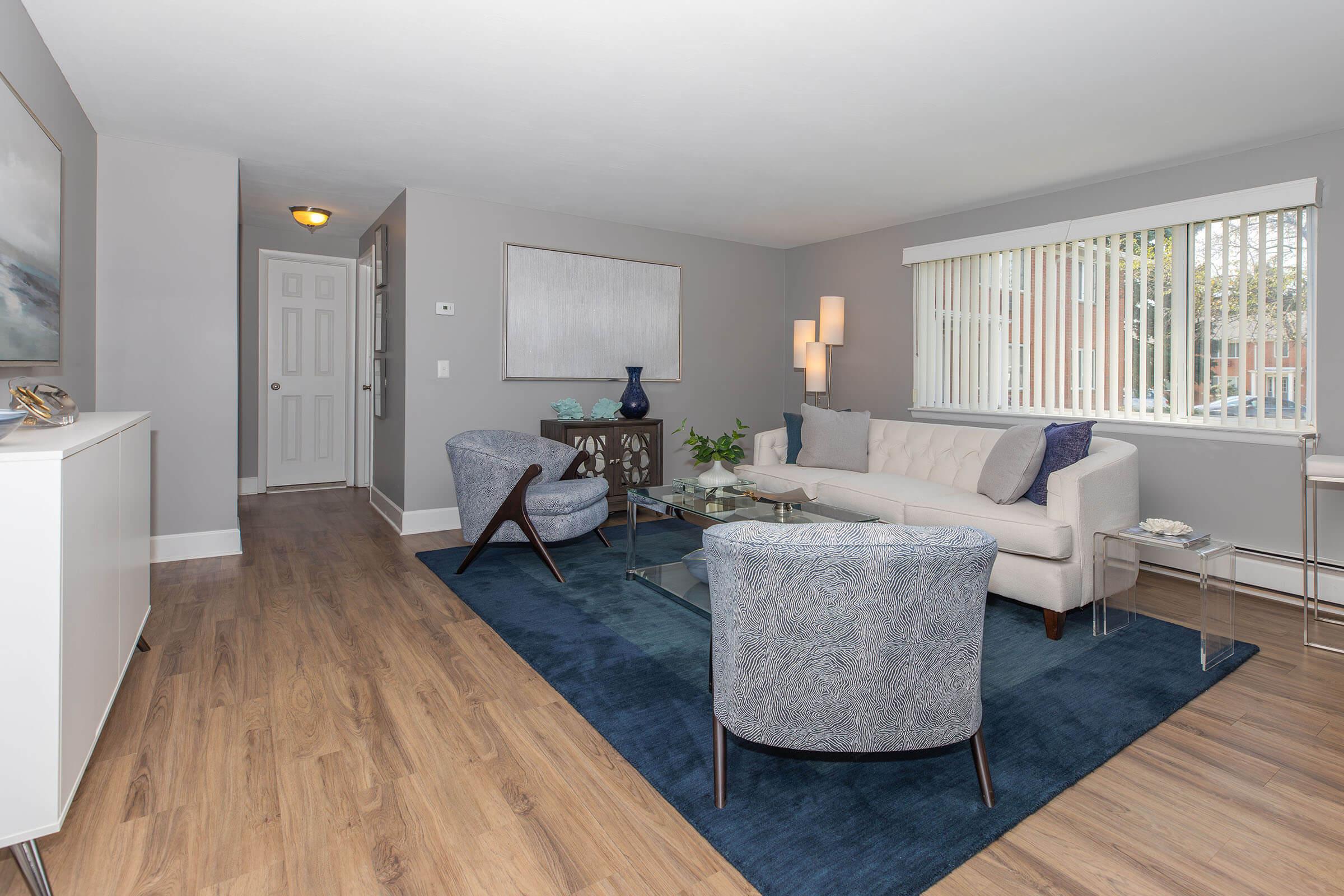 a living room filled with furniture and a large window