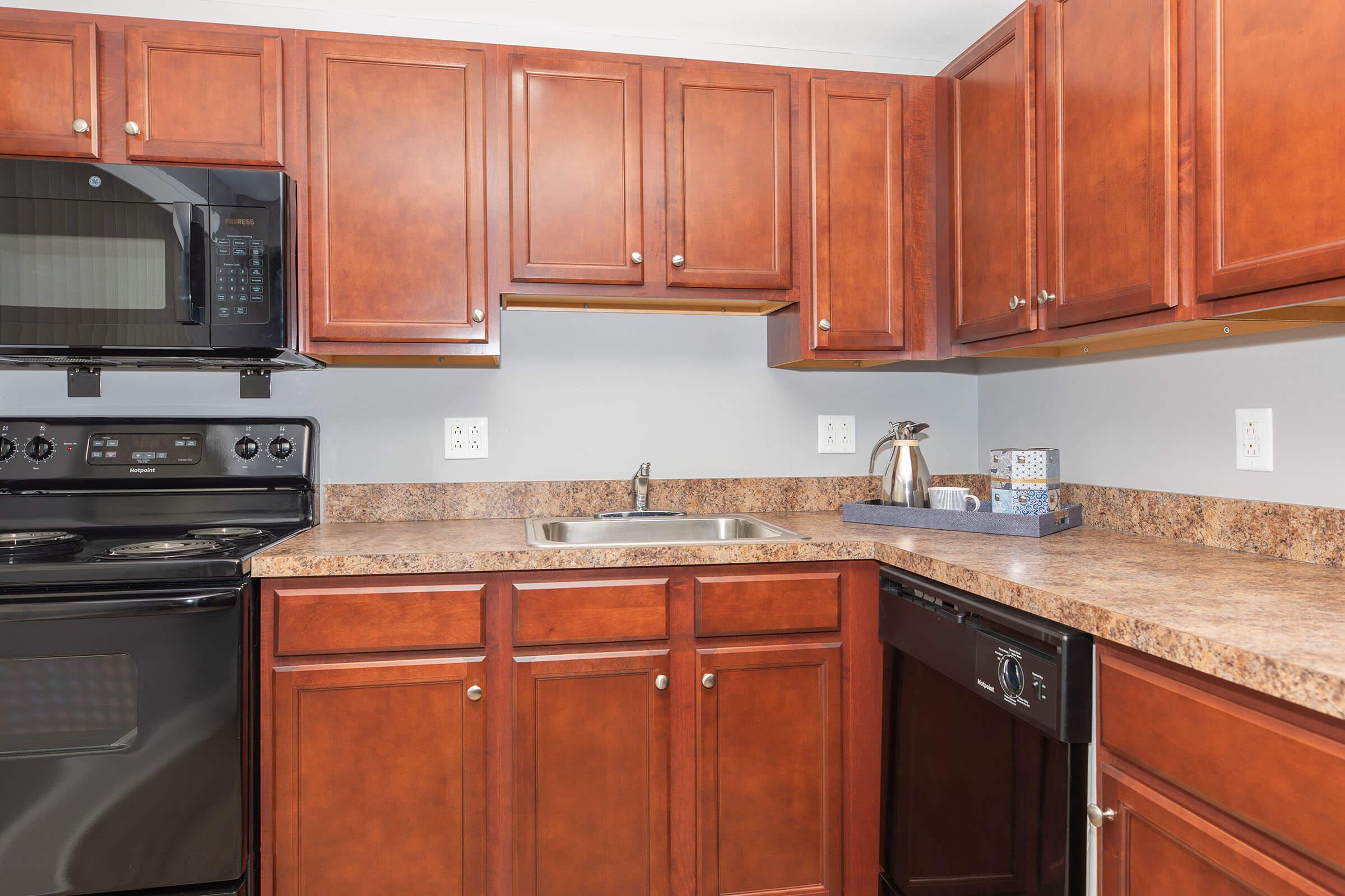 a kitchen with stainless steel appliances and wooden cabinets