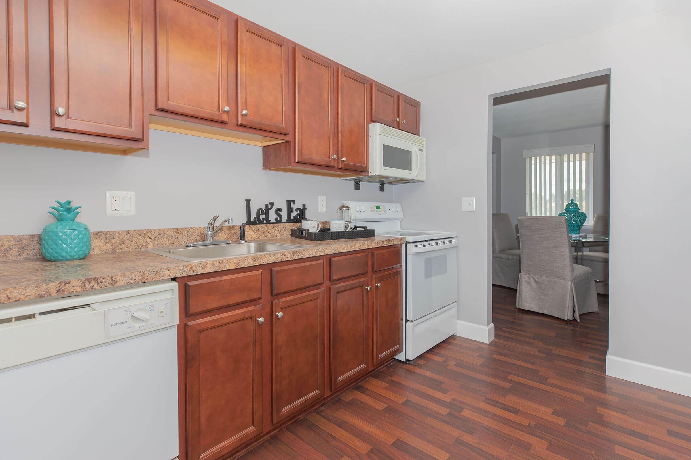 a kitchen with stainless steel appliances and wooden cabinets