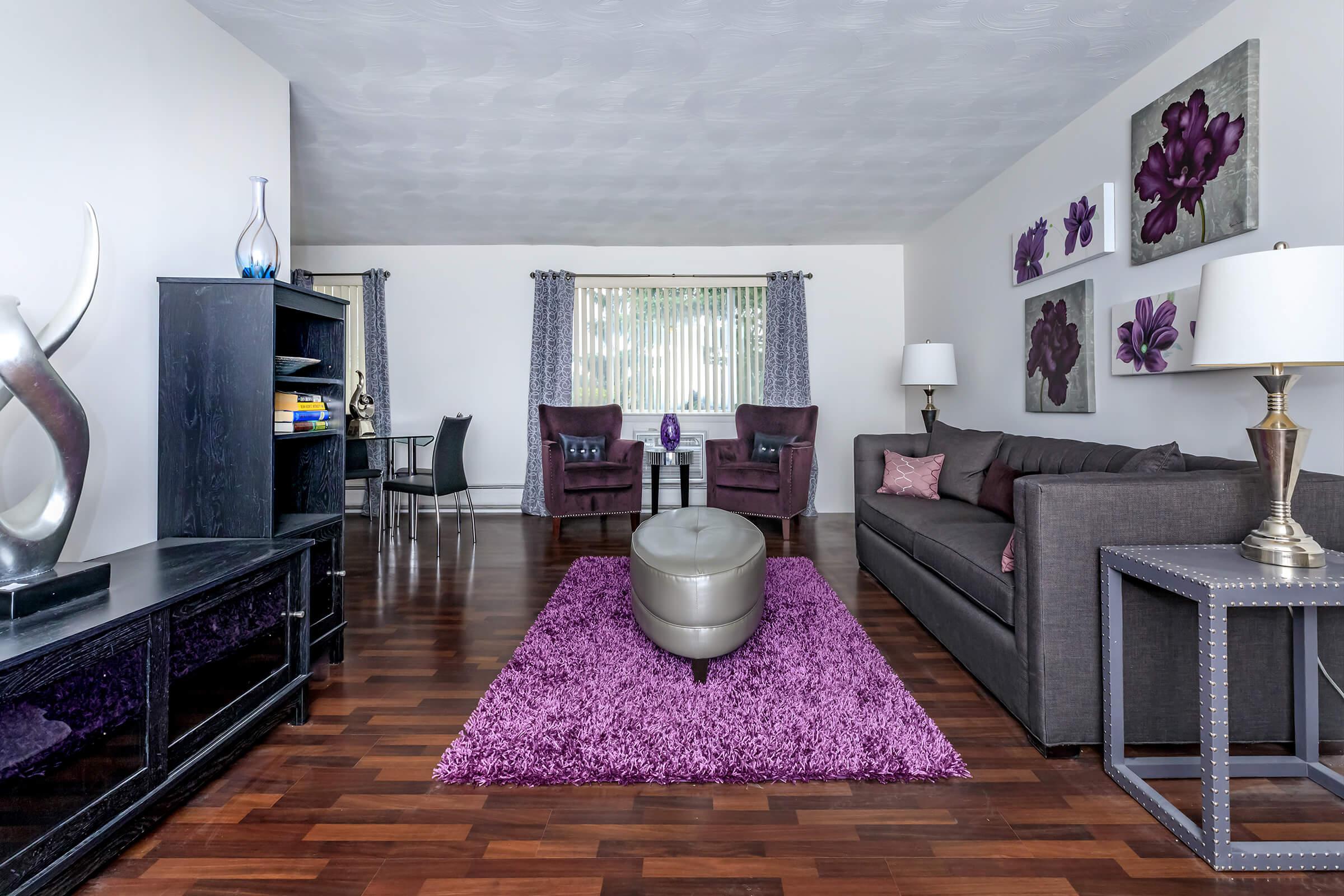 a living room filled with furniture and a flat screen tv