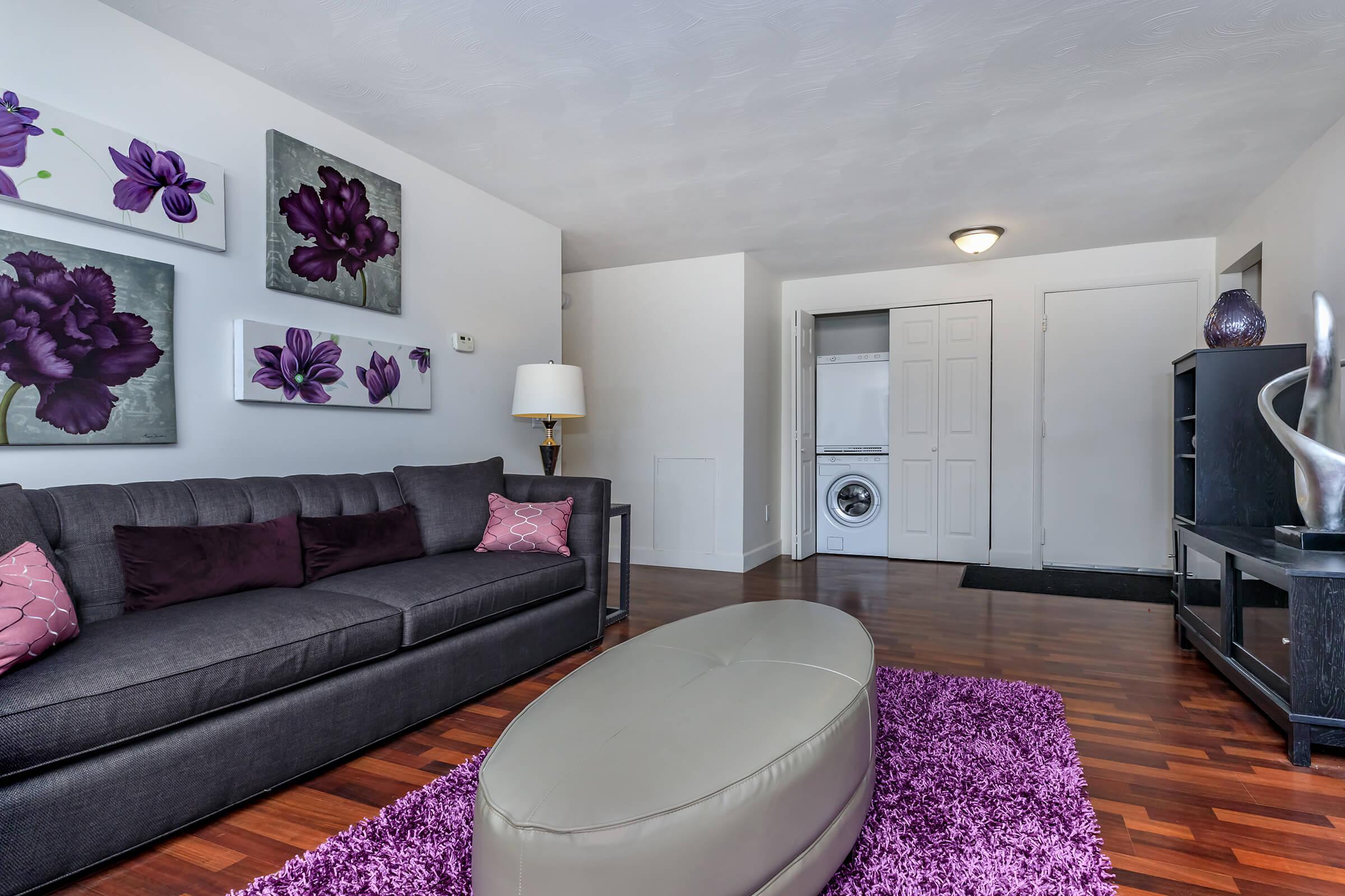 a living room filled with furniture and a flat screen tv