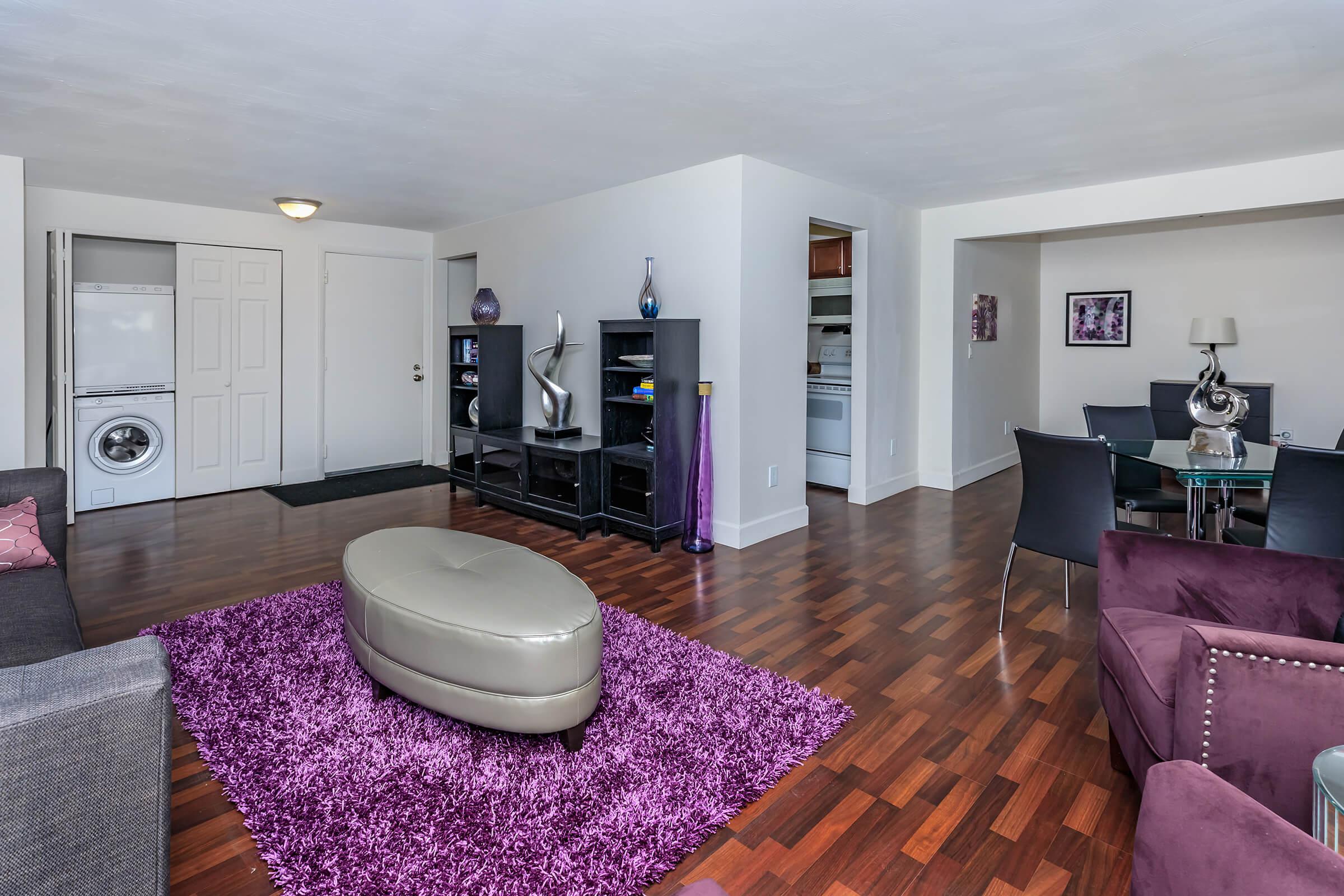 a living room filled with furniture and a flat screen tv