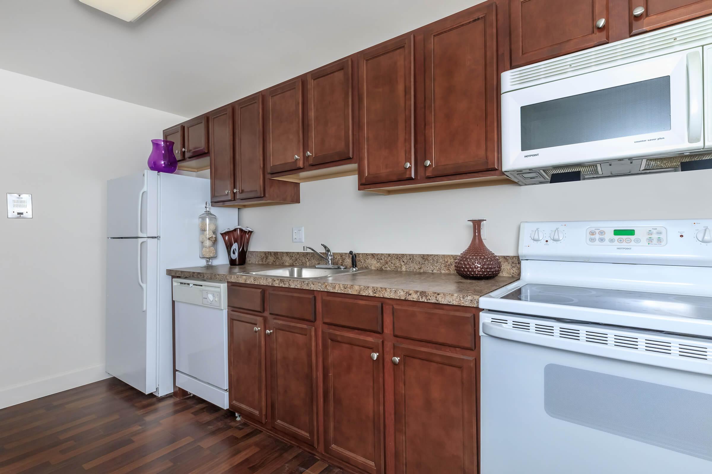 a kitchen with stainless steel appliances and wooden cabinets