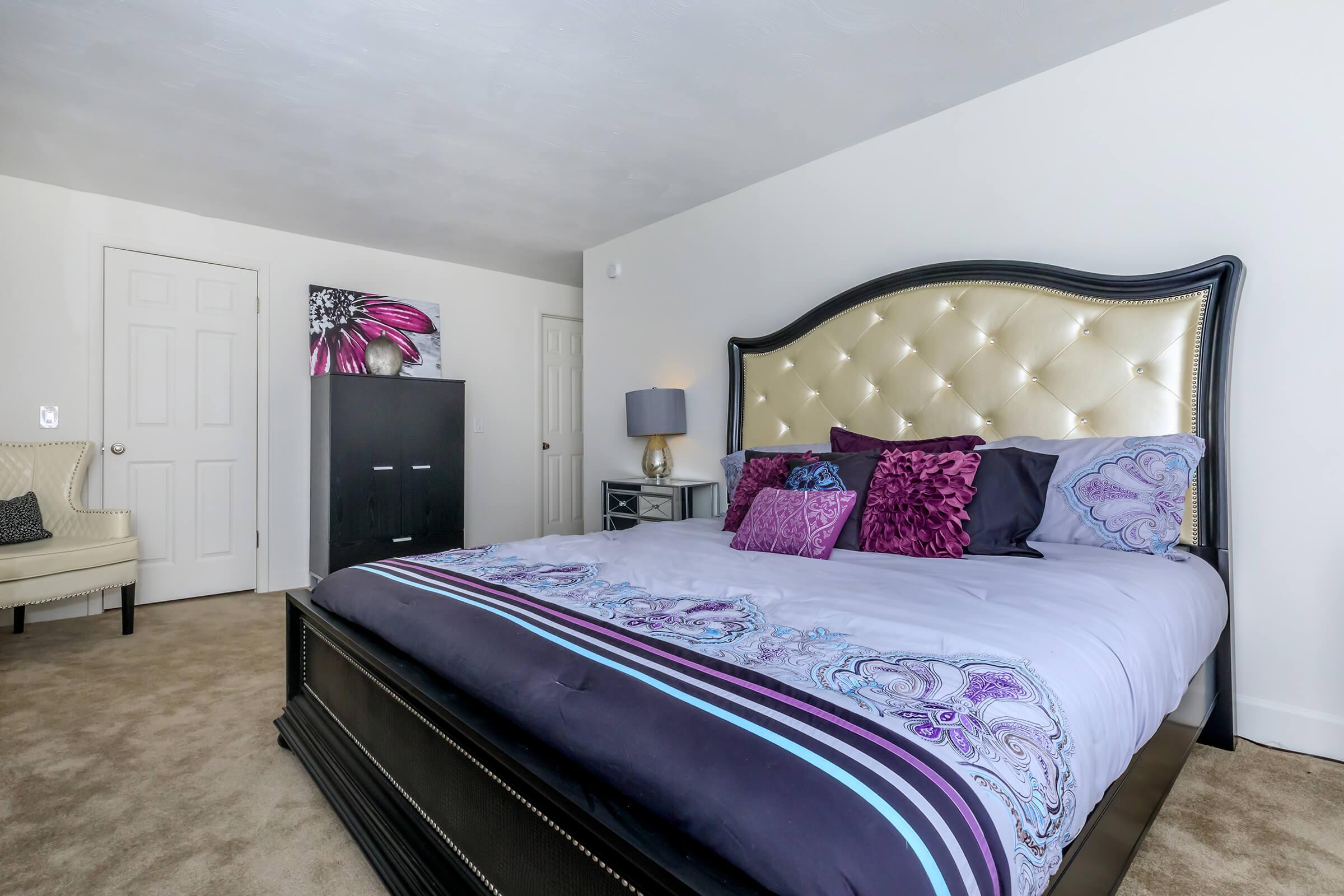 a bedroom with a large bed in a room