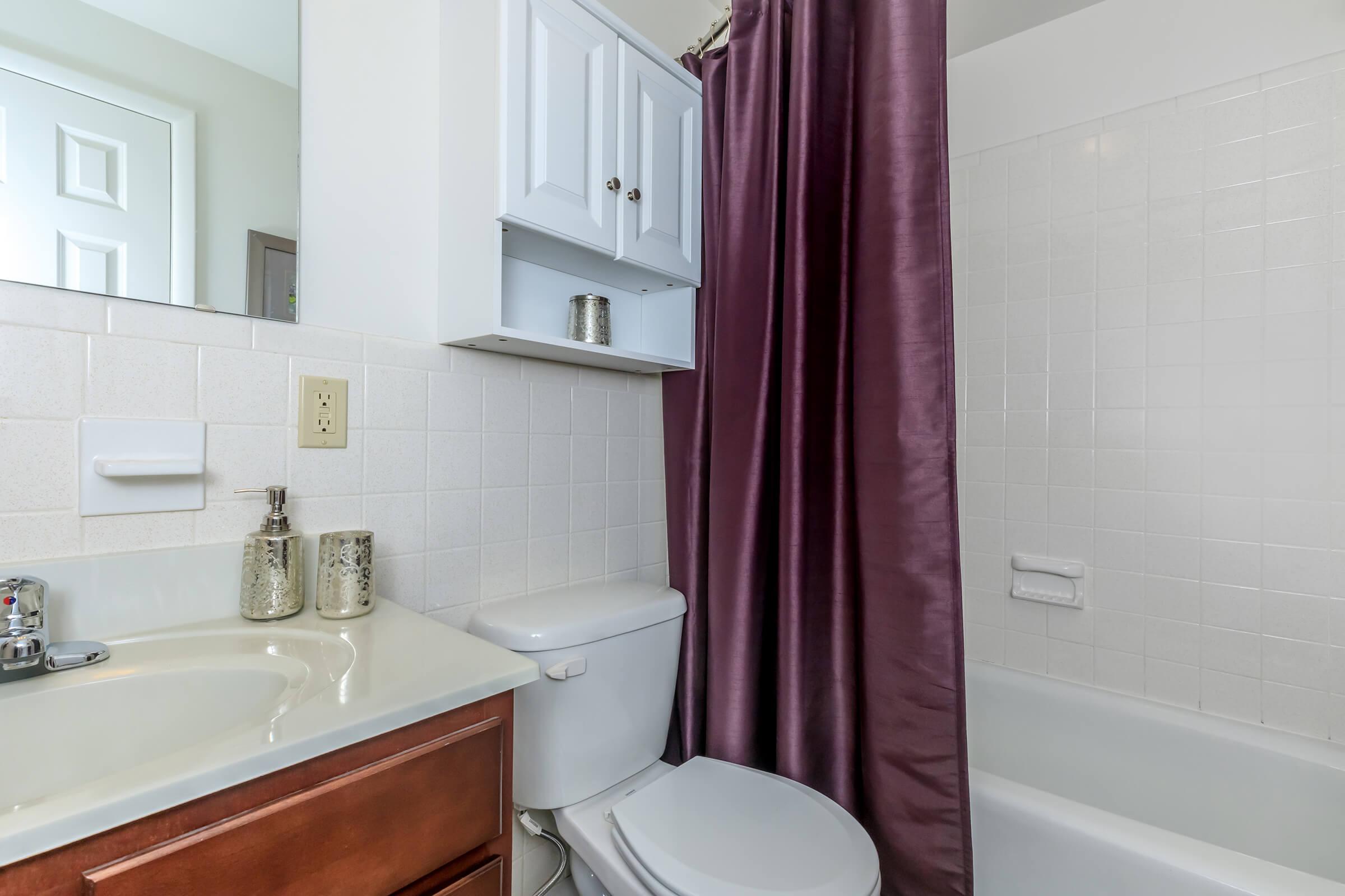 a white tub sitting next to a sink