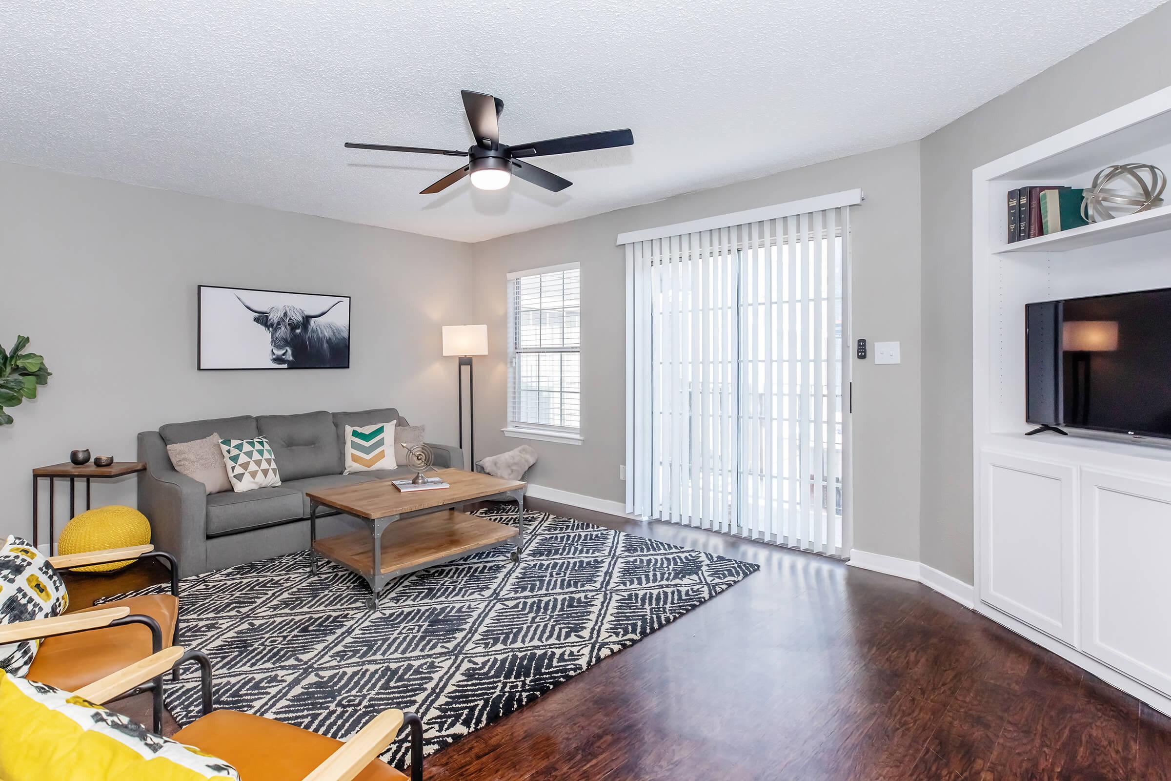 a living room filled with furniture and a large window